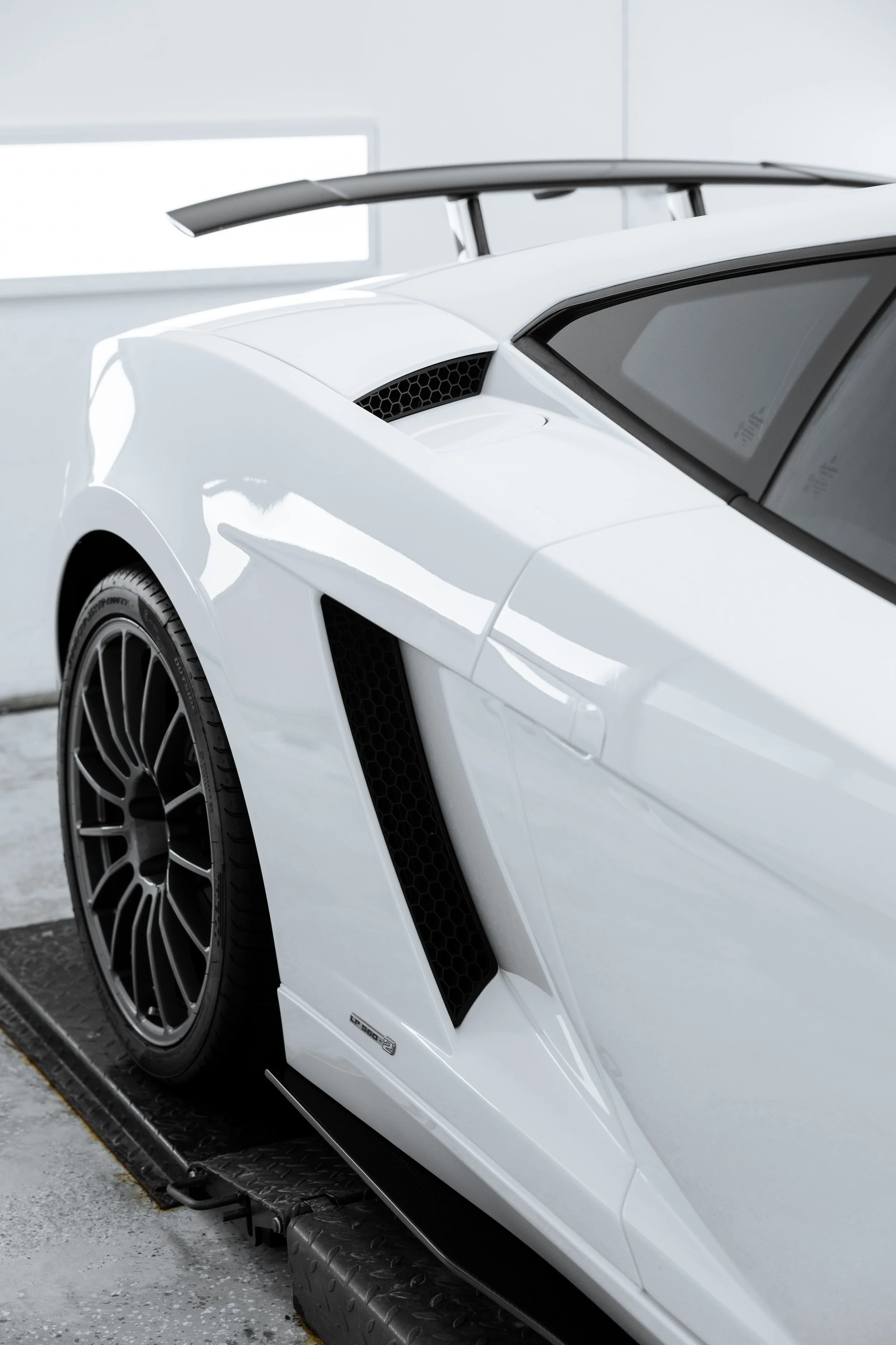White Lamborghini Gallardo rear quarter panel and side intake detail with full PPF by ADS in Mona Vale