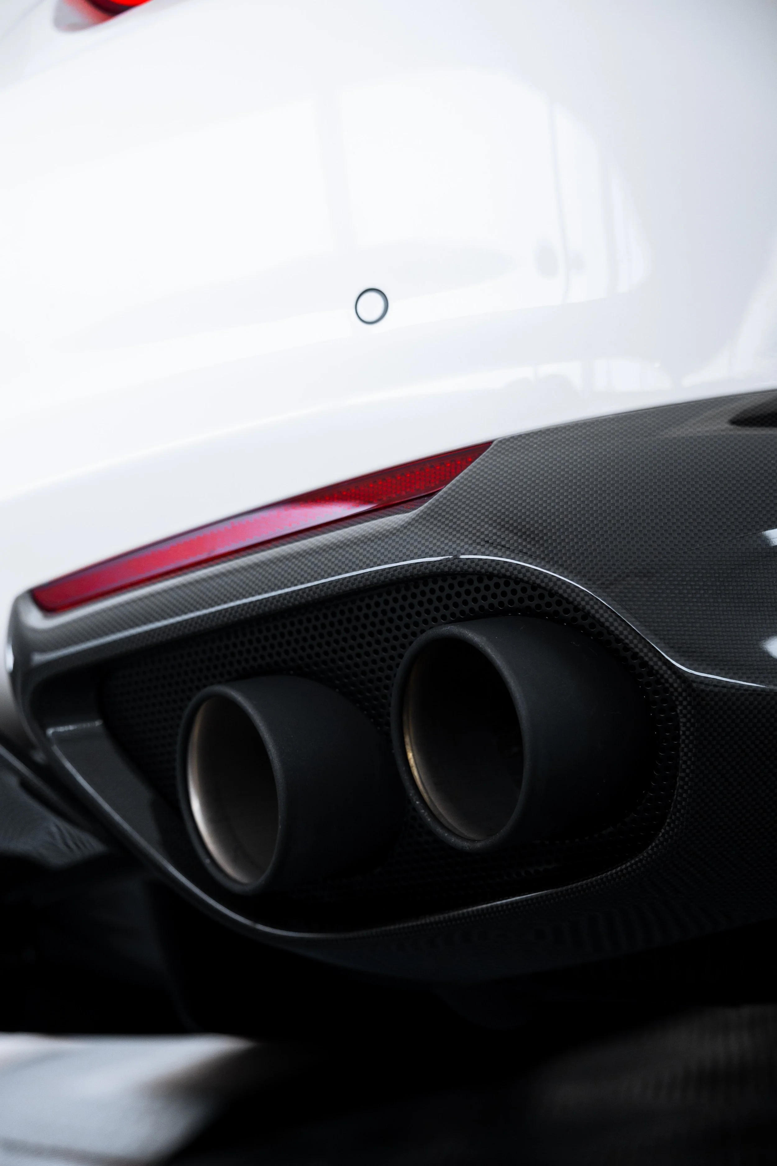 White Ferrari 812 GTS quad exhaust tip detail with XPEL Paint Protection Film in Mona Vale