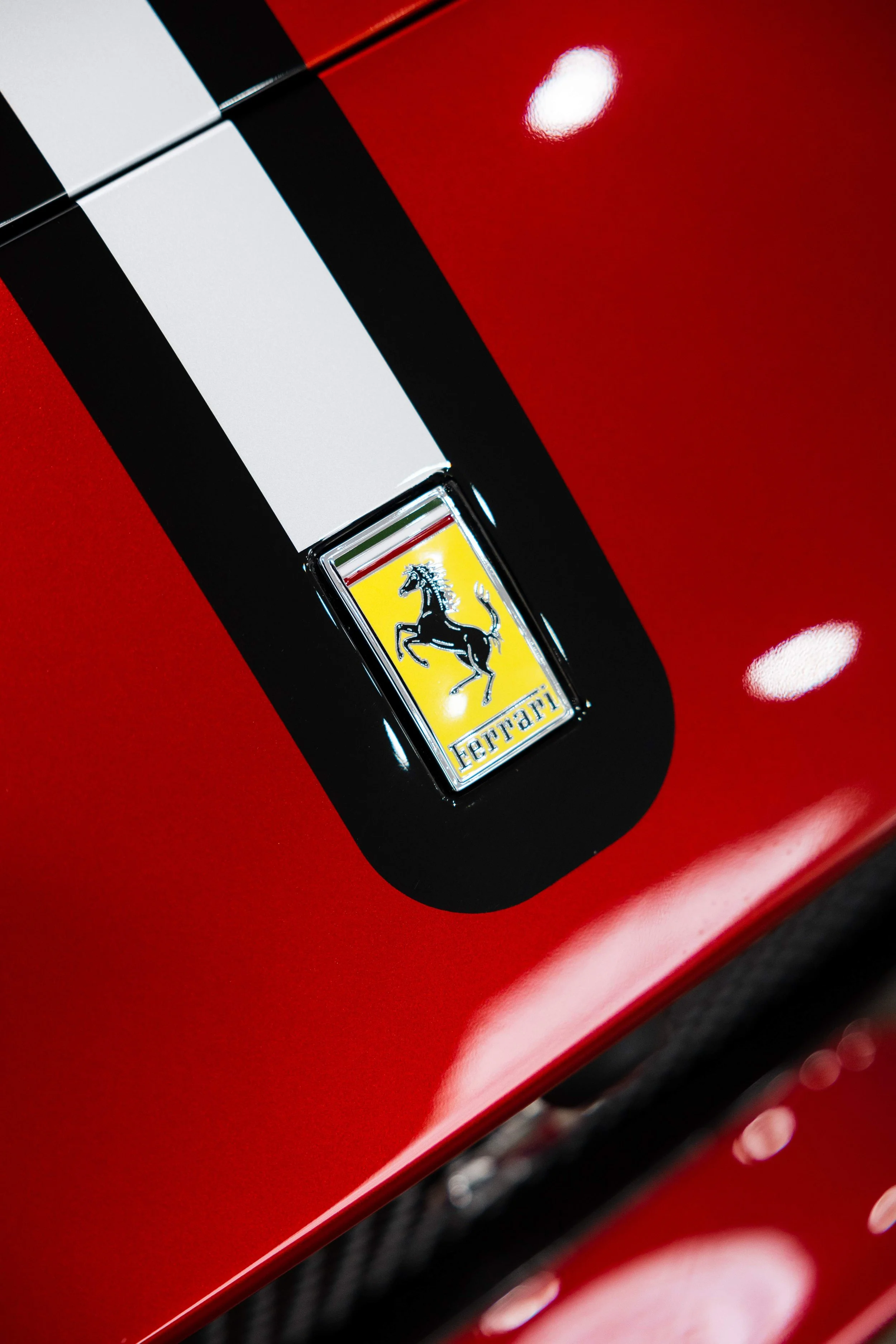 Red Ferrari 812 GTS bonnet stripe and Ferrari badge detail with XPEL Paint Protection Film in Sydney
