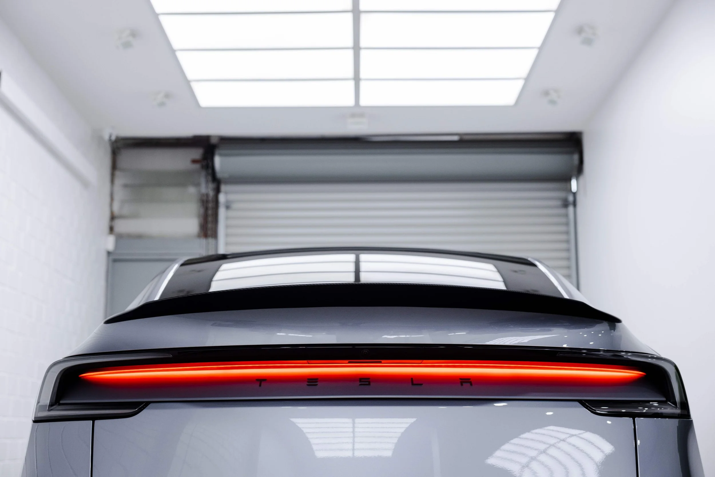 Silver Tesla Model Y rear view in studio with XPEL Paint Protection Film in Mona Vale