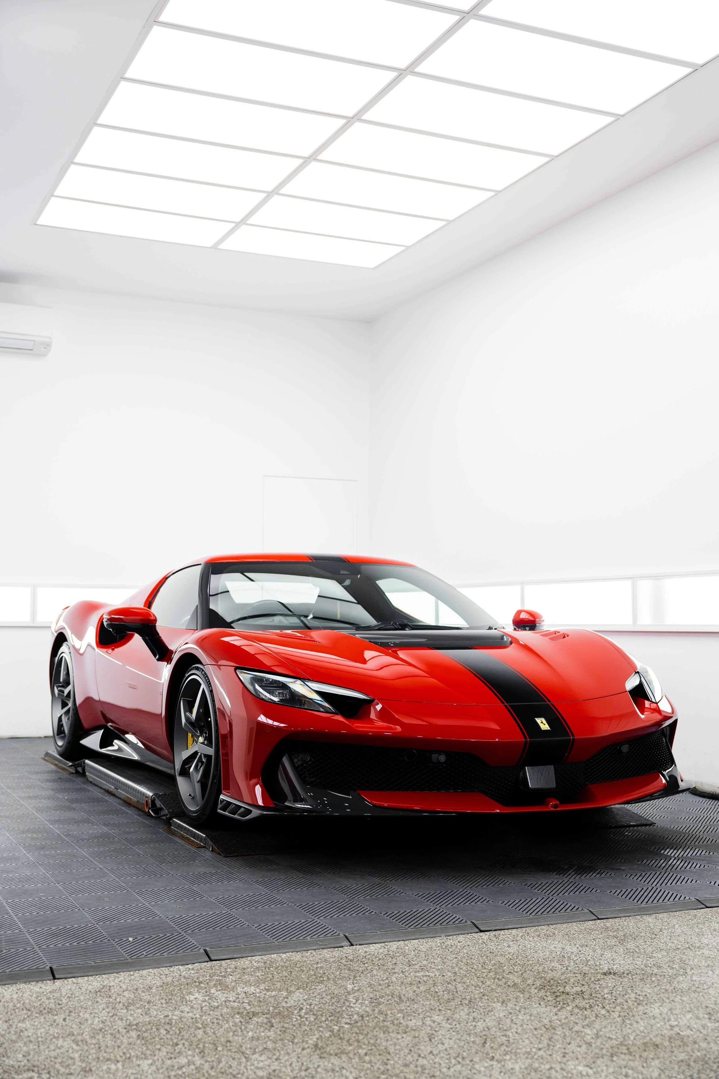 Red Ferrari 296 Speciale low front three quarter in studio with XPEL Paint Protection Film in Mona Vale