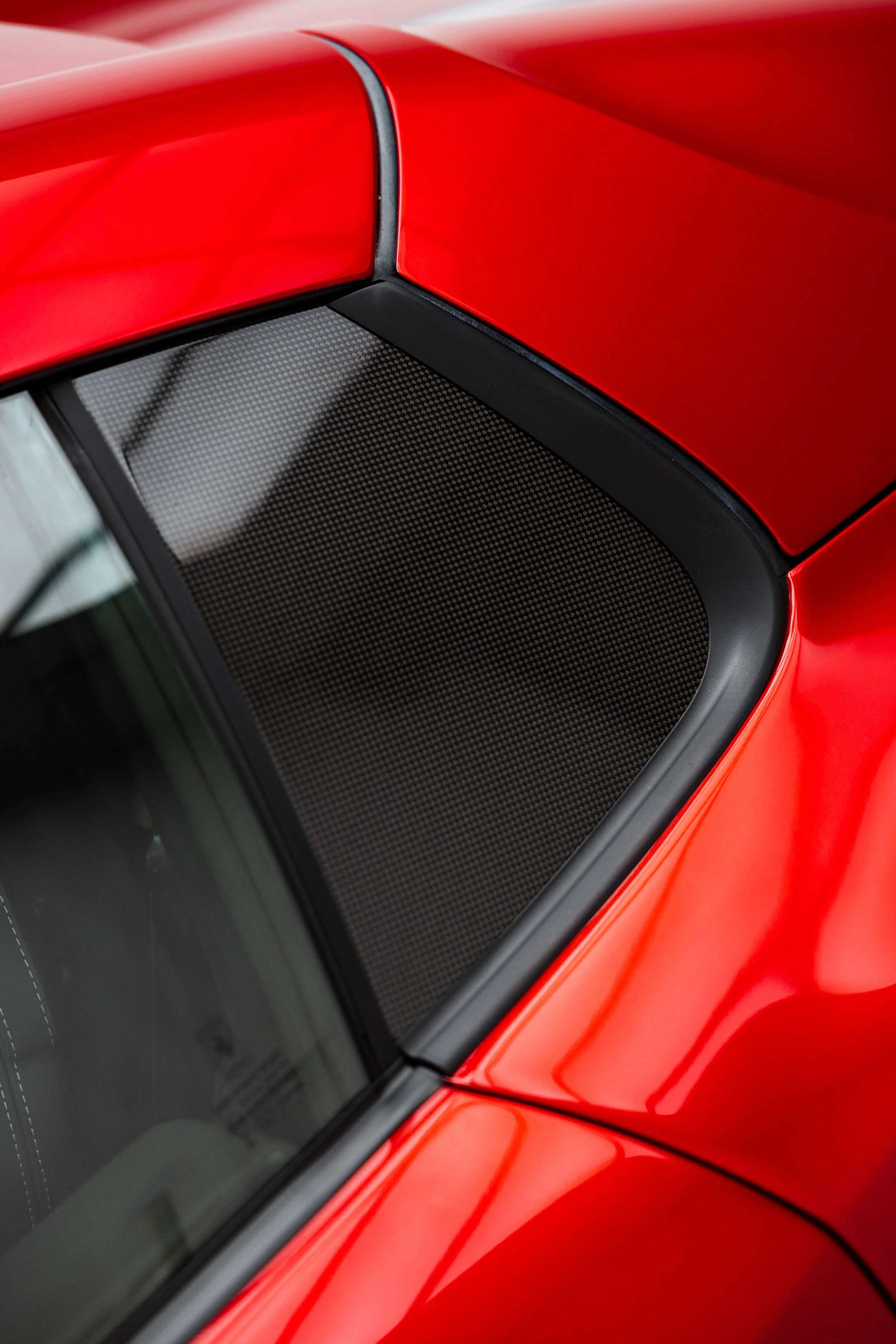 Red Ferrari 812 GTS rear quarter window and carbon trim with XPEL Paint Protection Film in Sydney