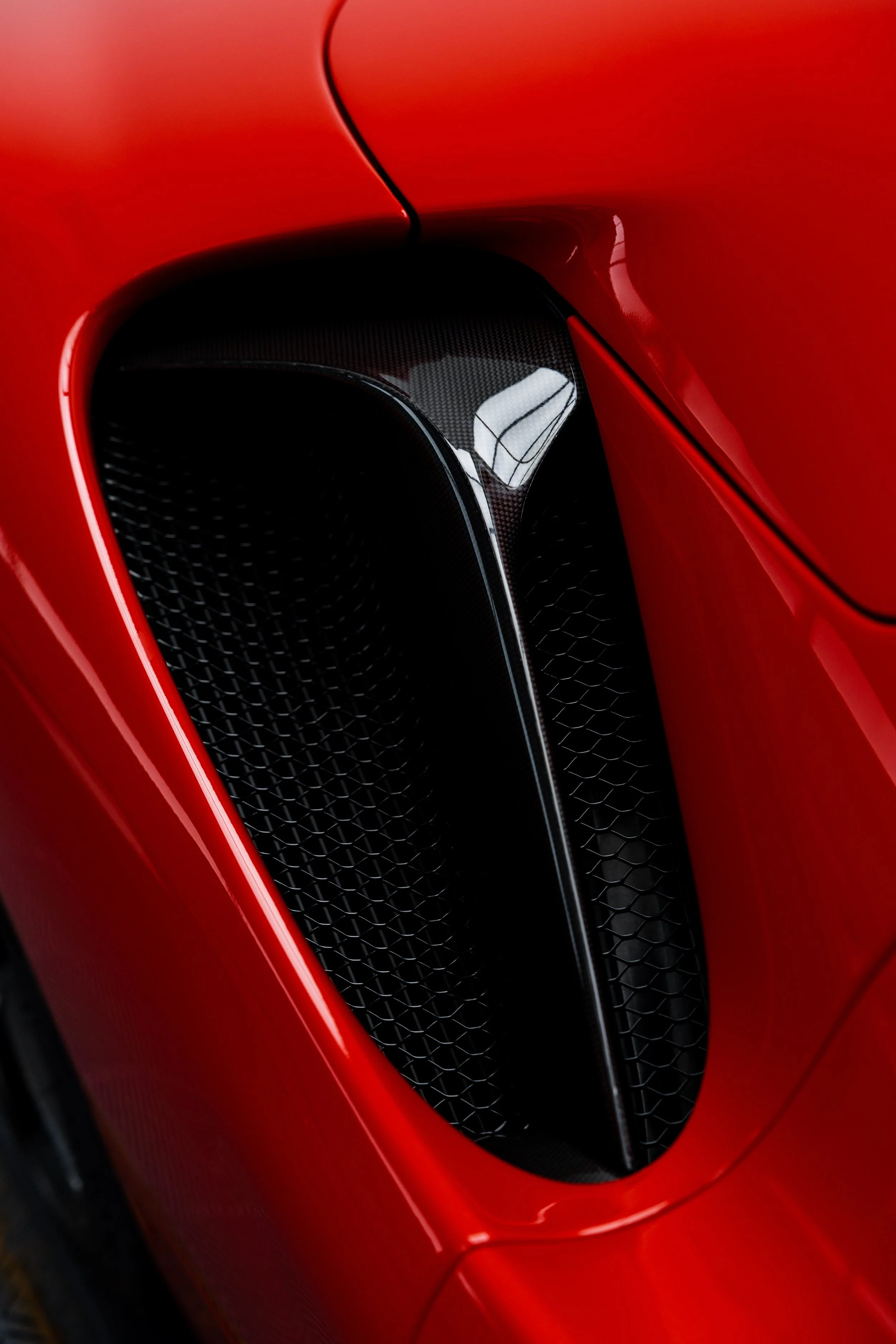 Red Ferrari SF90 Spyder rear quarter air intake with XPEL Paint Protection Film in Sydney