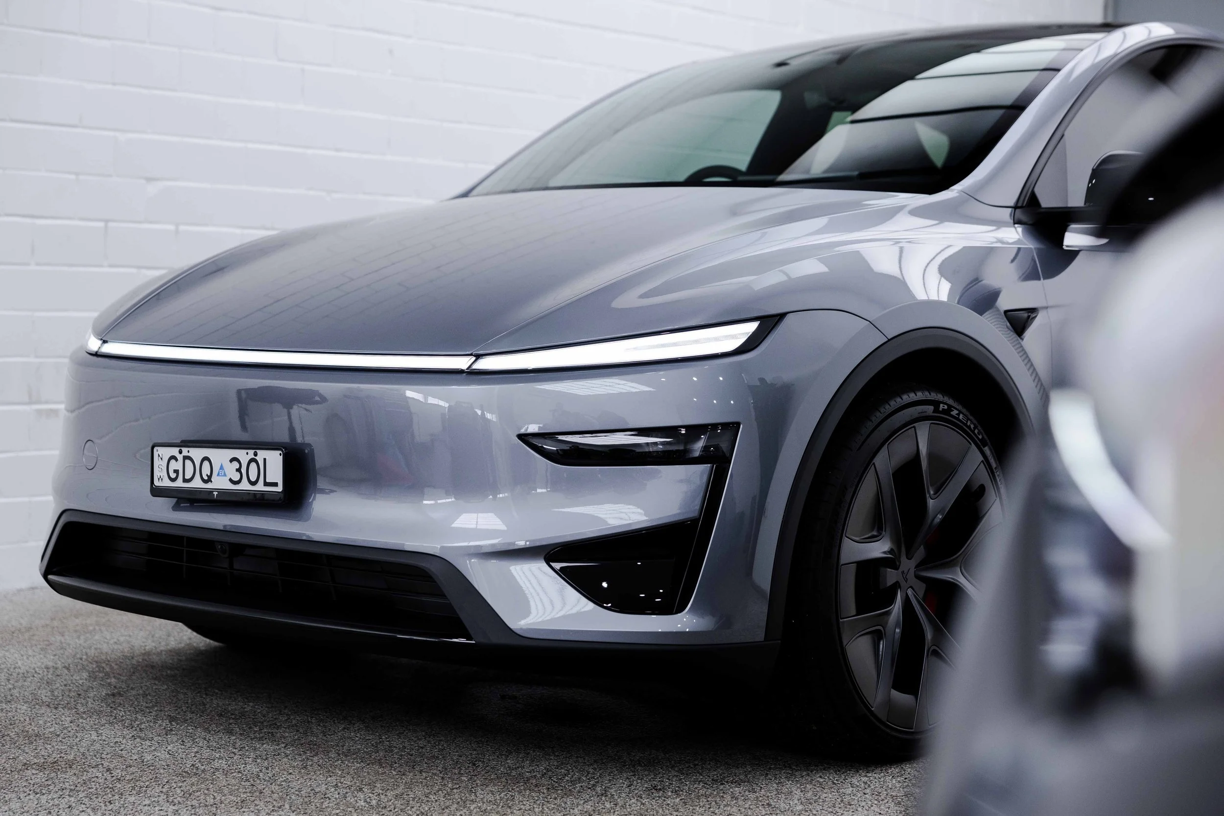 Silver Tesla Model Y front quarter and light bar with XPEL Paint Protection Film in Sydney