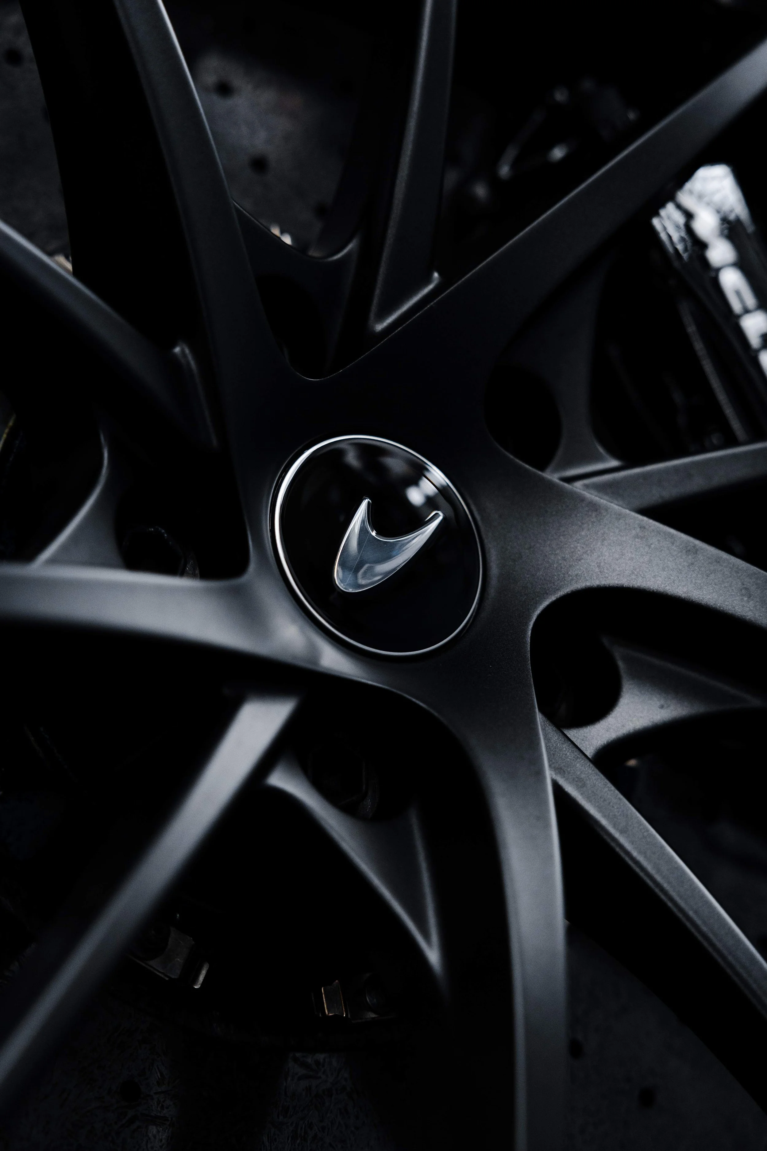 Black McLaren 750S wheel centre cap and matte spoke detail with XPEL Paint Protection Film in Sydney