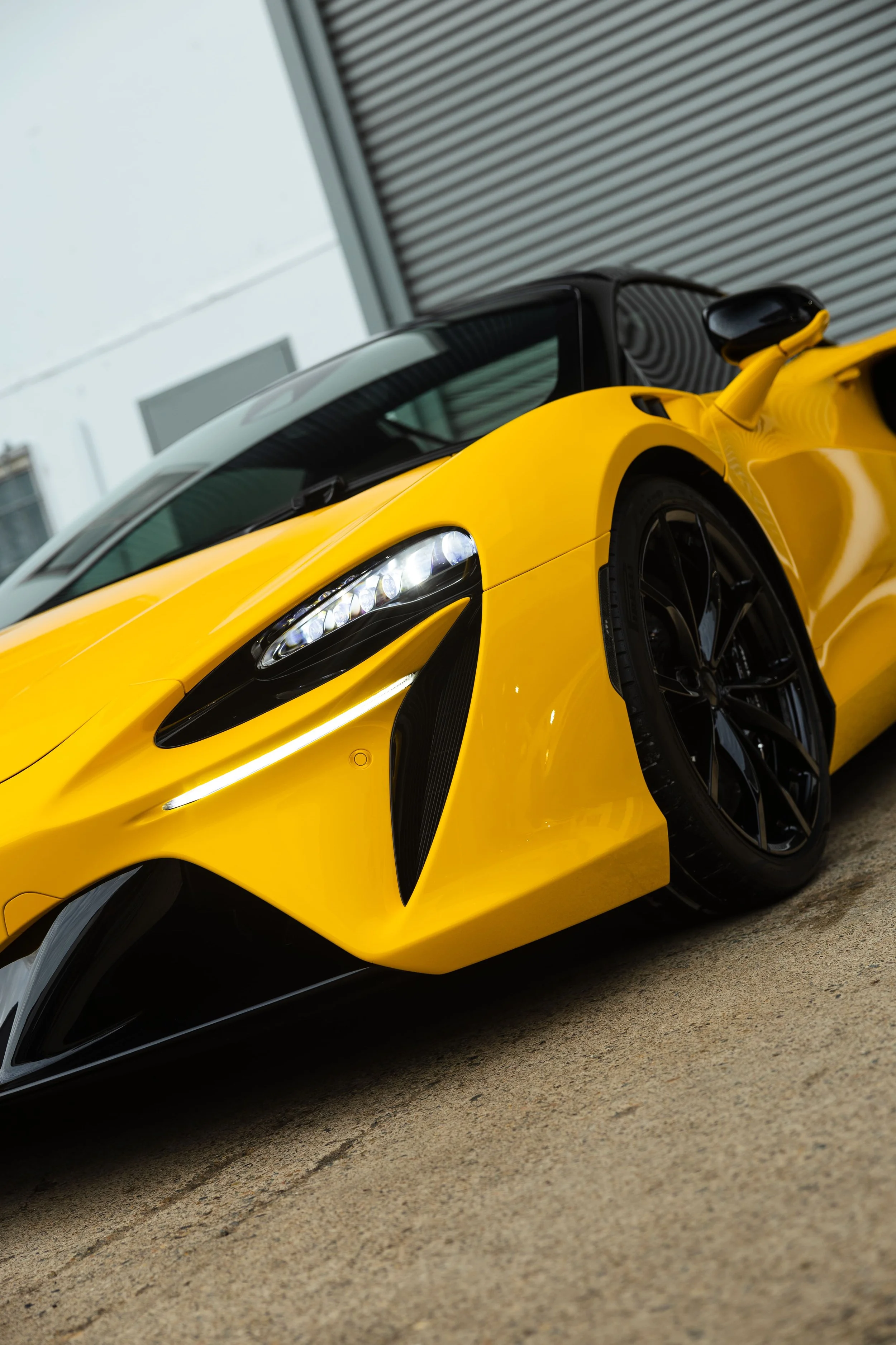 Yellow McLaren Artura front quarter view with PPF protection by ADS in Mona Vale