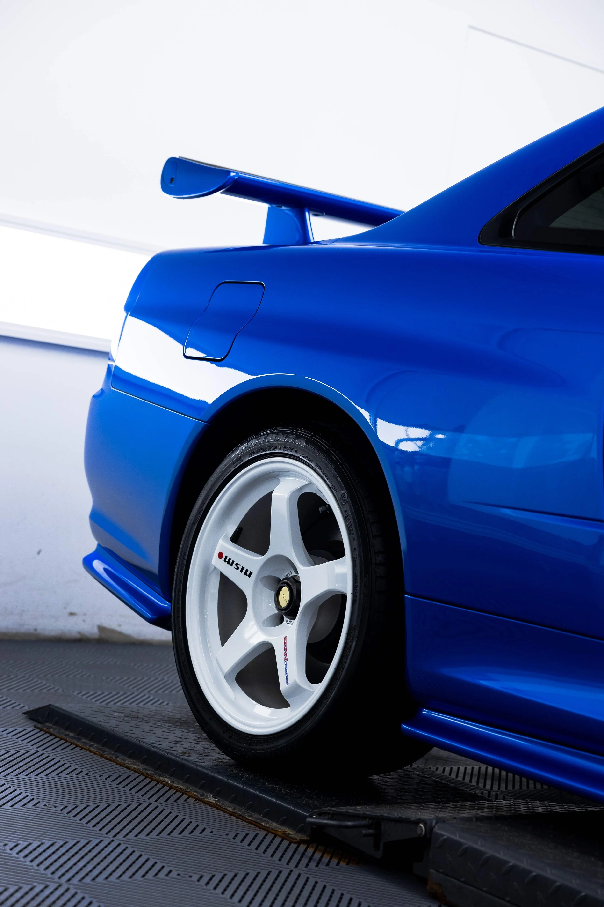 Bayside blue Nissan R34 GT-R Nur front guard and wheel with XPEL Paint Protection Film in Sydney