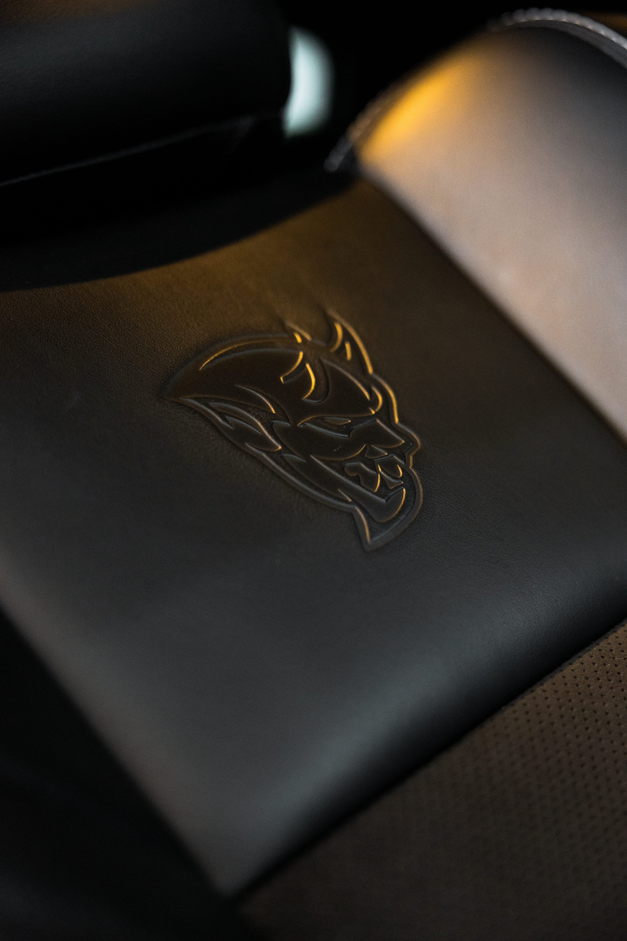 Interior close-up of Dodge Challenger SRT Demon seat with embossed logo, protected and detailed by ADS in Mona Vale