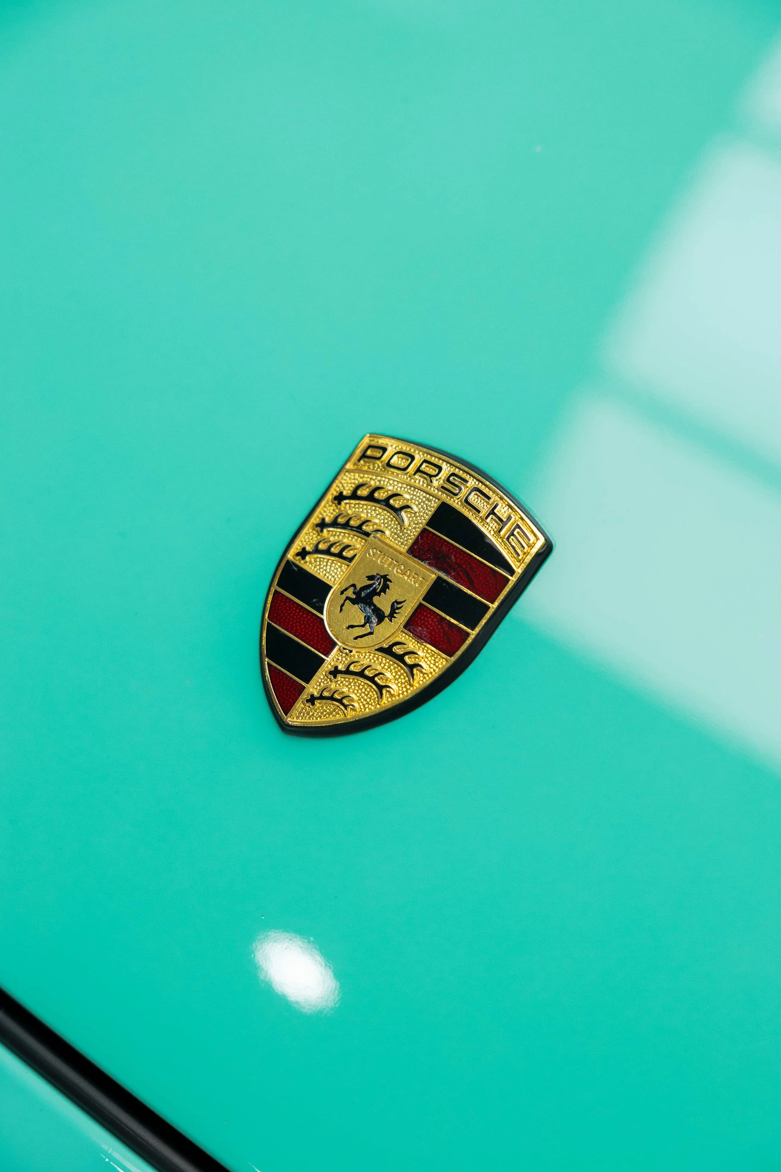 Porsche badge on mint green 993 bonnet with XPEL Paint Protection Film in Sydney