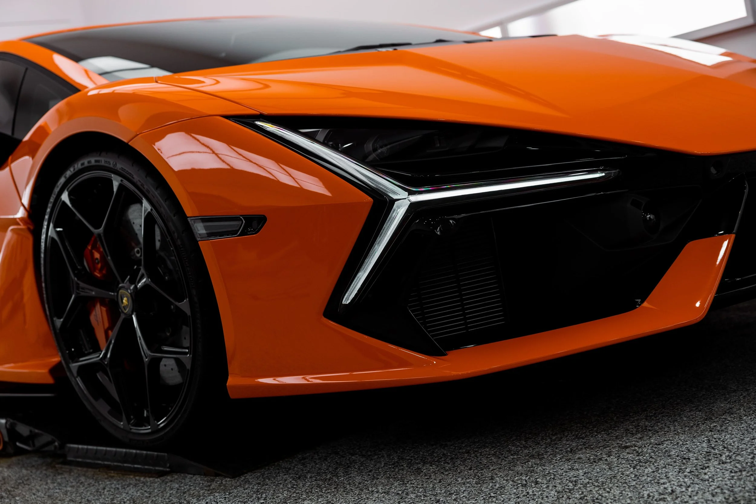 Orange Lamborghini Revuelto front headlight and bumper detail with full PPF by ADS in Mona Vale