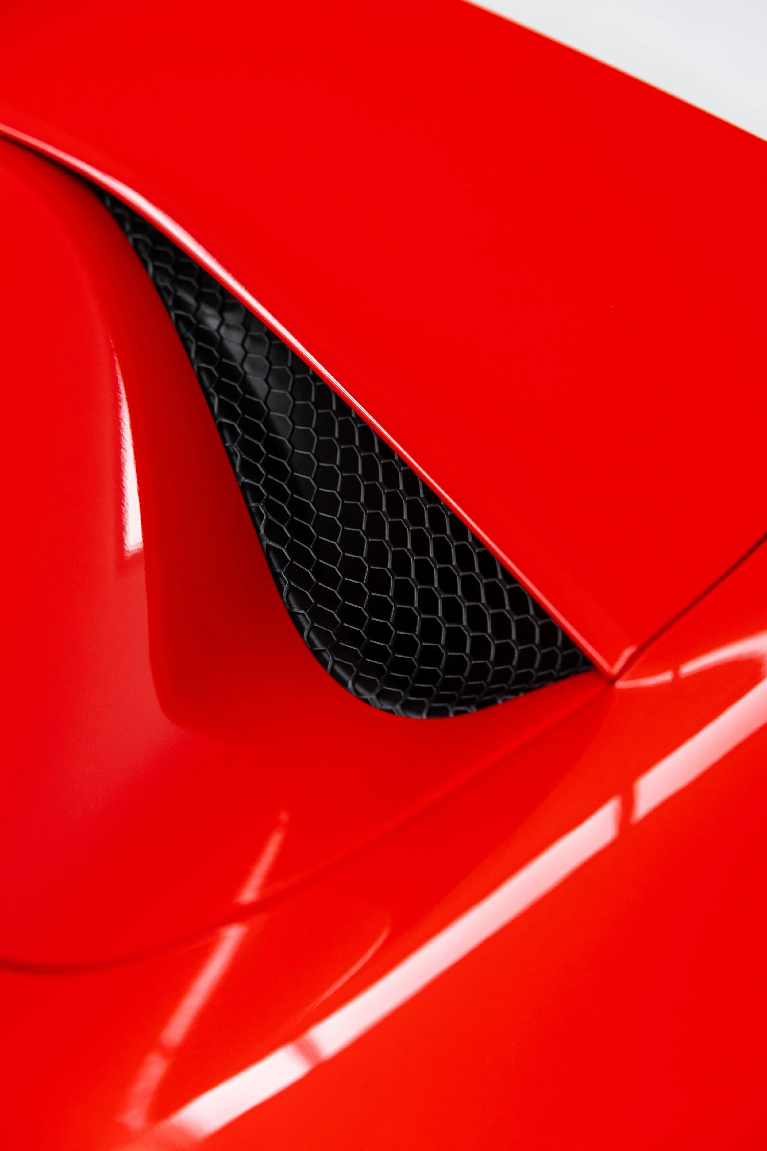 Red Ferrari 296 GTS side air vent and guard detail with XPEL Paint Protection Film in Mona Vale