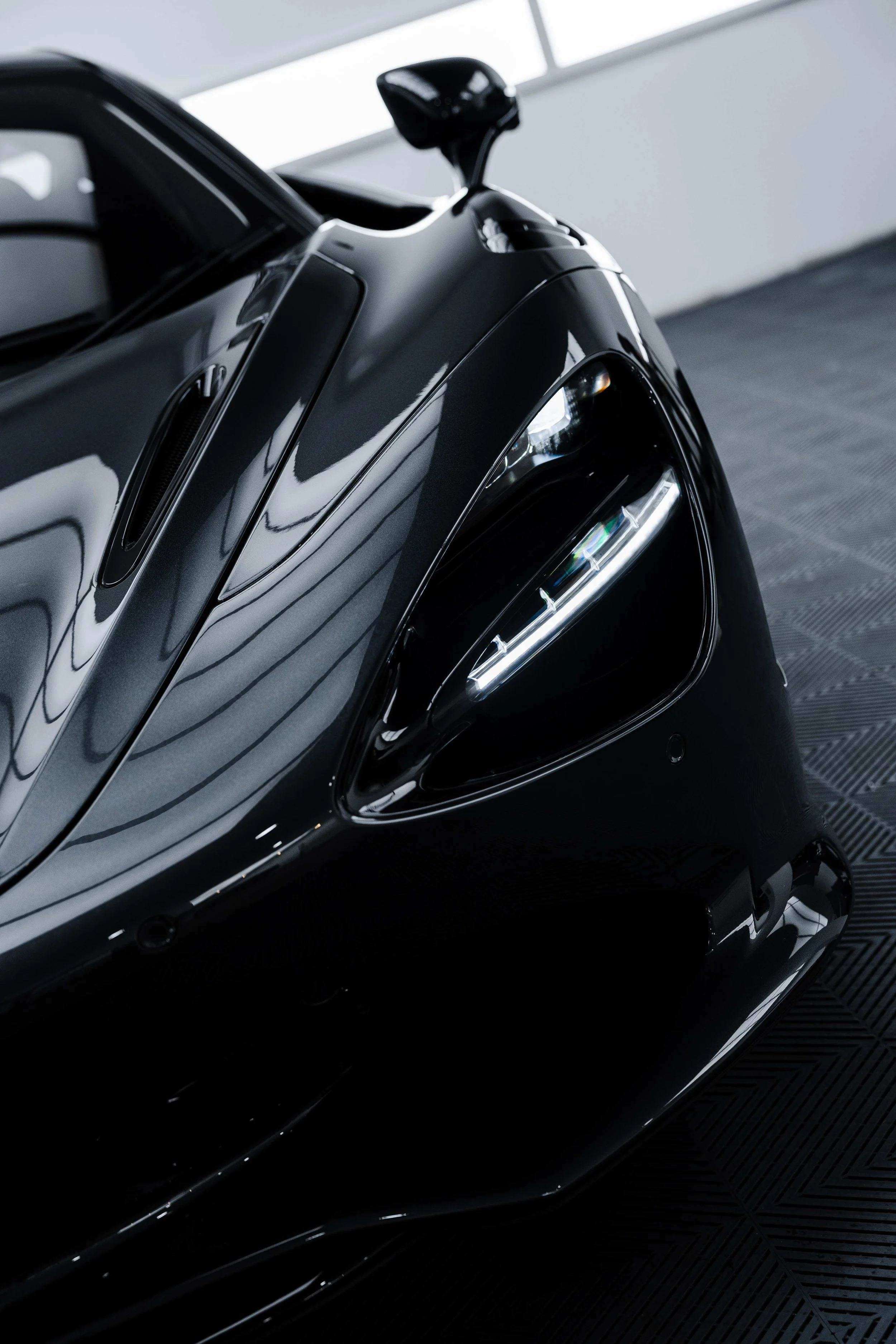 Black McLaren 750S front guard and headlight with XPEL Paint Protection Film in Mona Vale