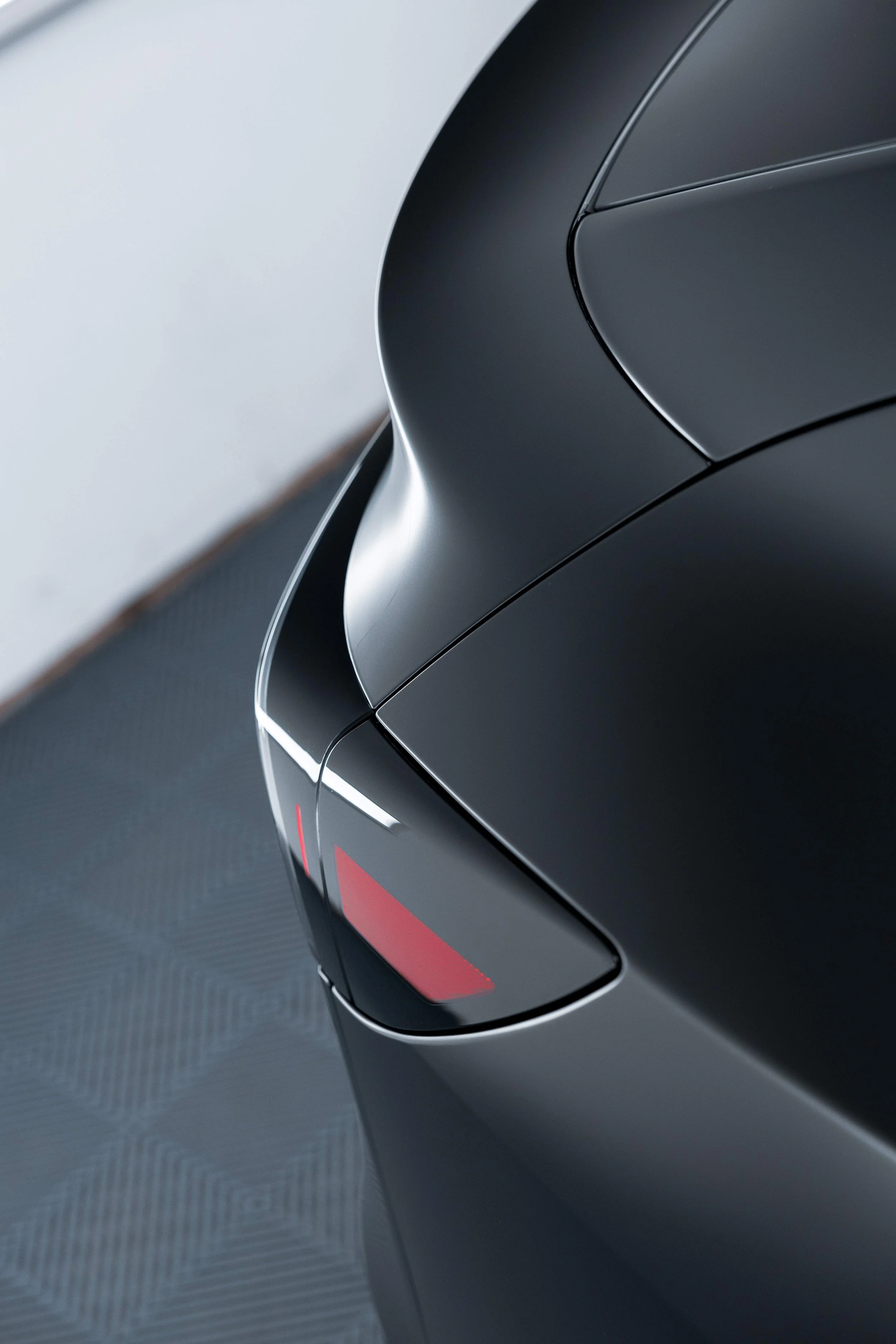 Matte black Tesla Model Y rear pillar and tail light with XPEL Stealth Paint Protection Film in Mona Vale
