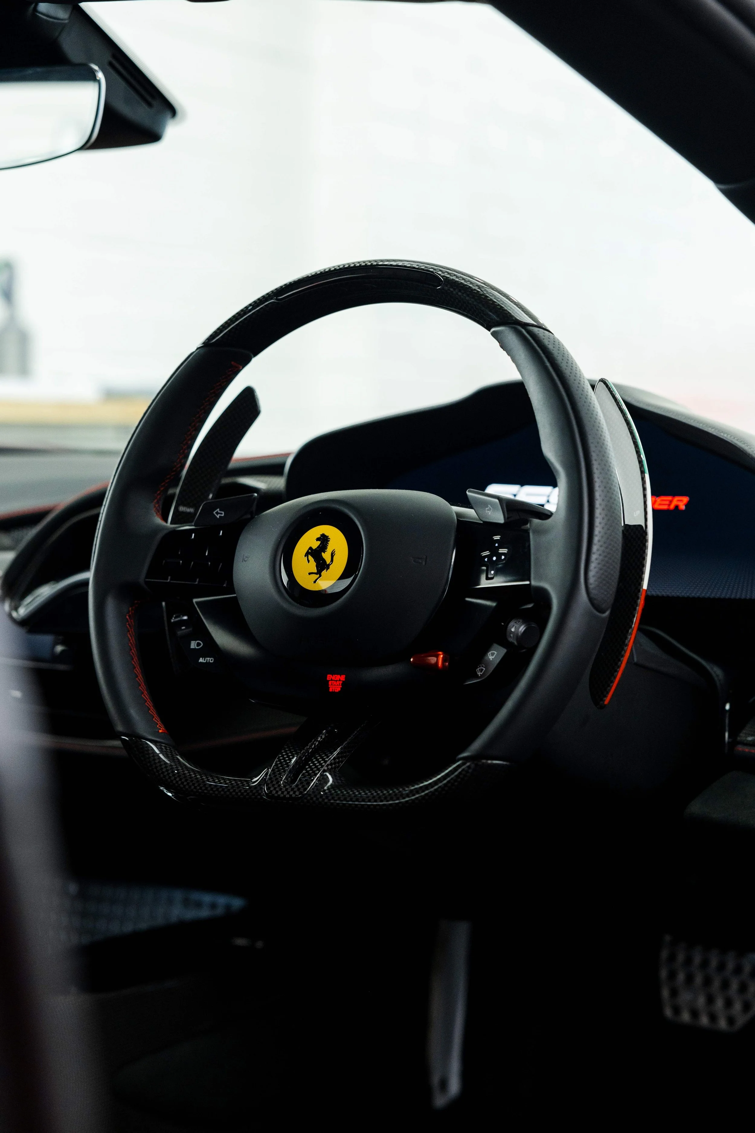 Red Ferrari SF90 Spyder interior detailing steering wheel and Prancing Horse badge in Sydney