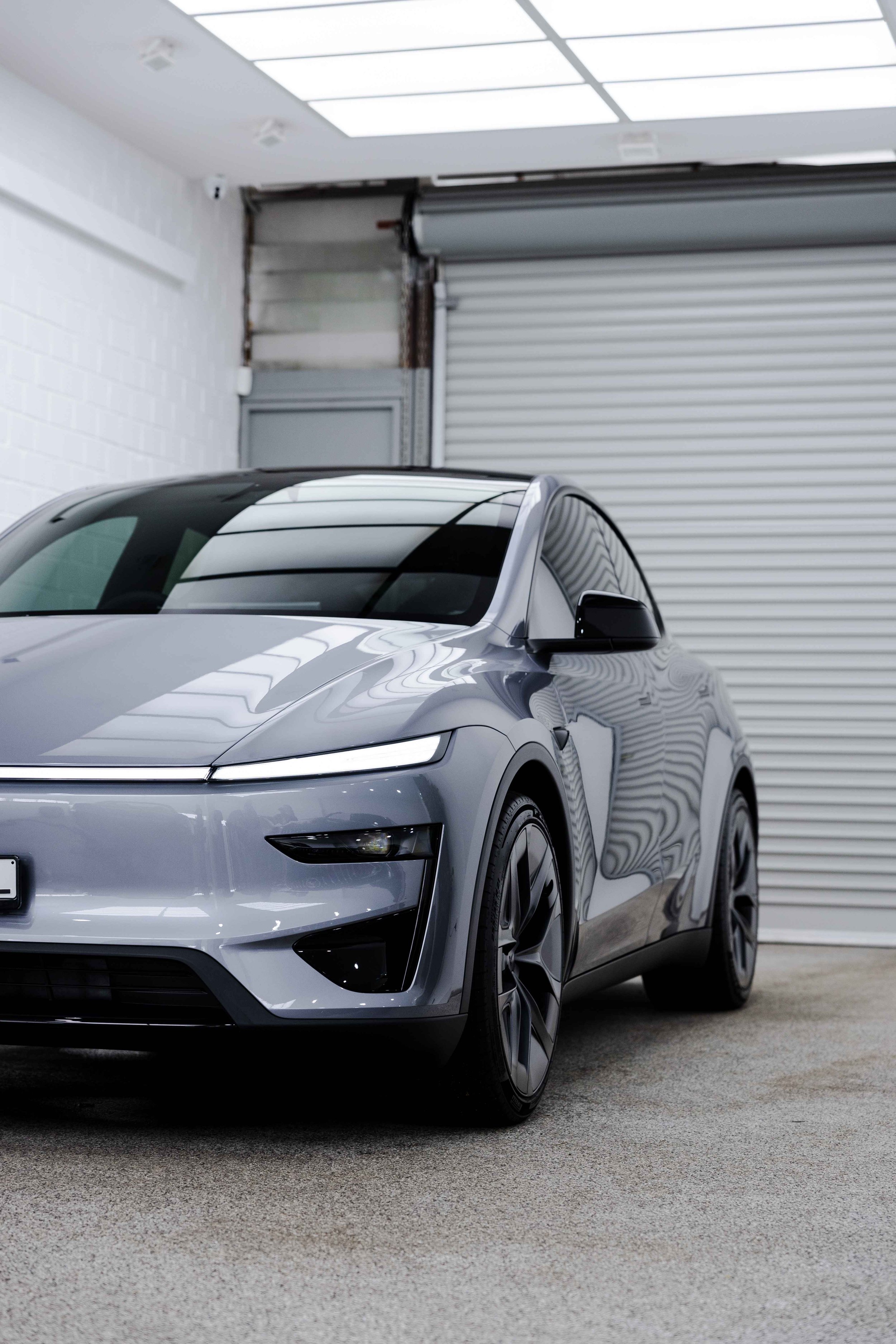 Silver Tesla Model Y front three quarter roofline with XPEL Paint Protection Film in Mona Vale