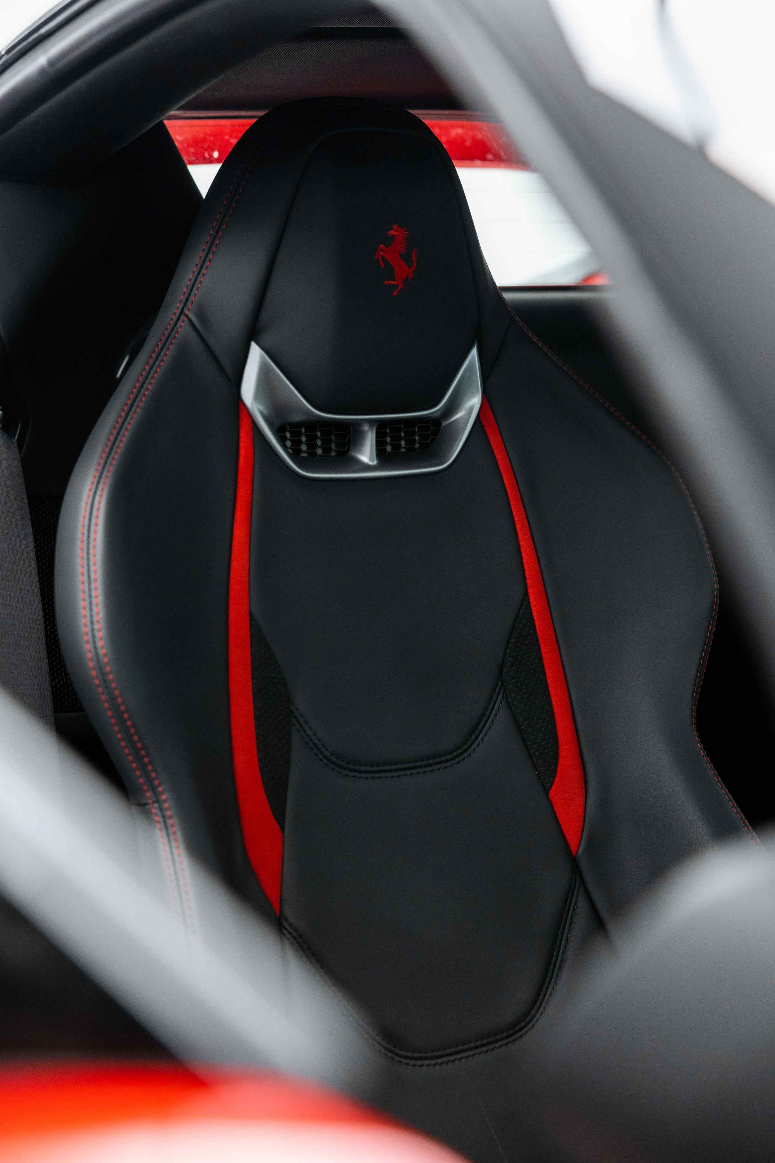 Red Ferrari 296 GTS interior detailing seat with Ferrari shield stitching in Sydney