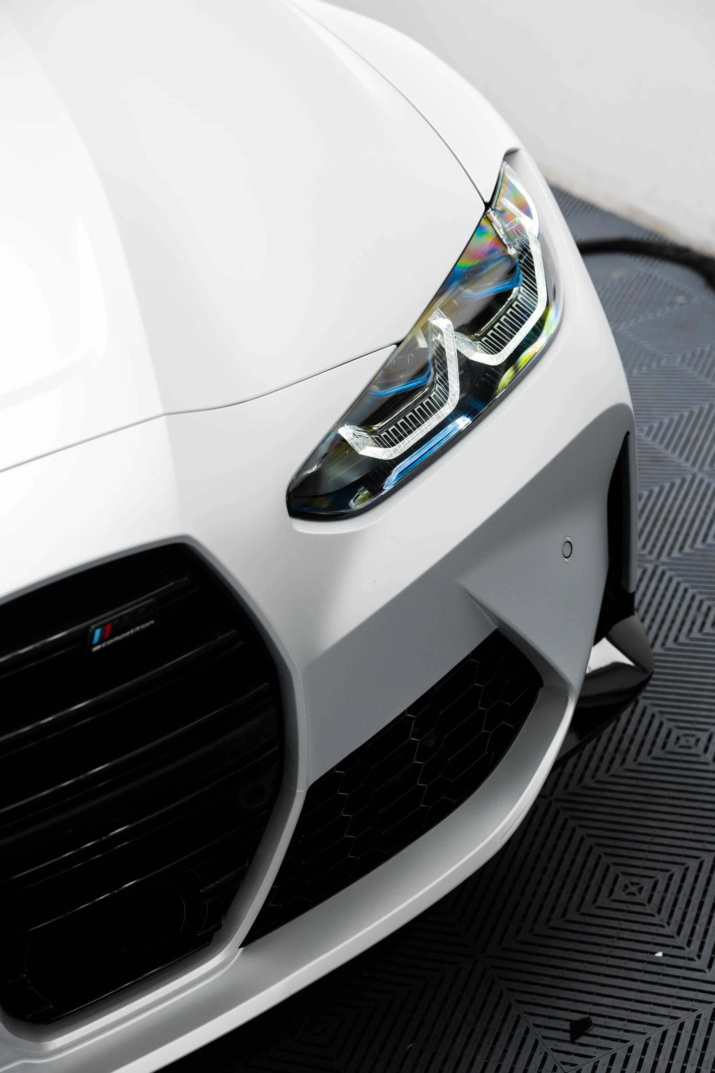 White BMW M4 Competition headlight with XPEL Paint Protection Film in Sydney