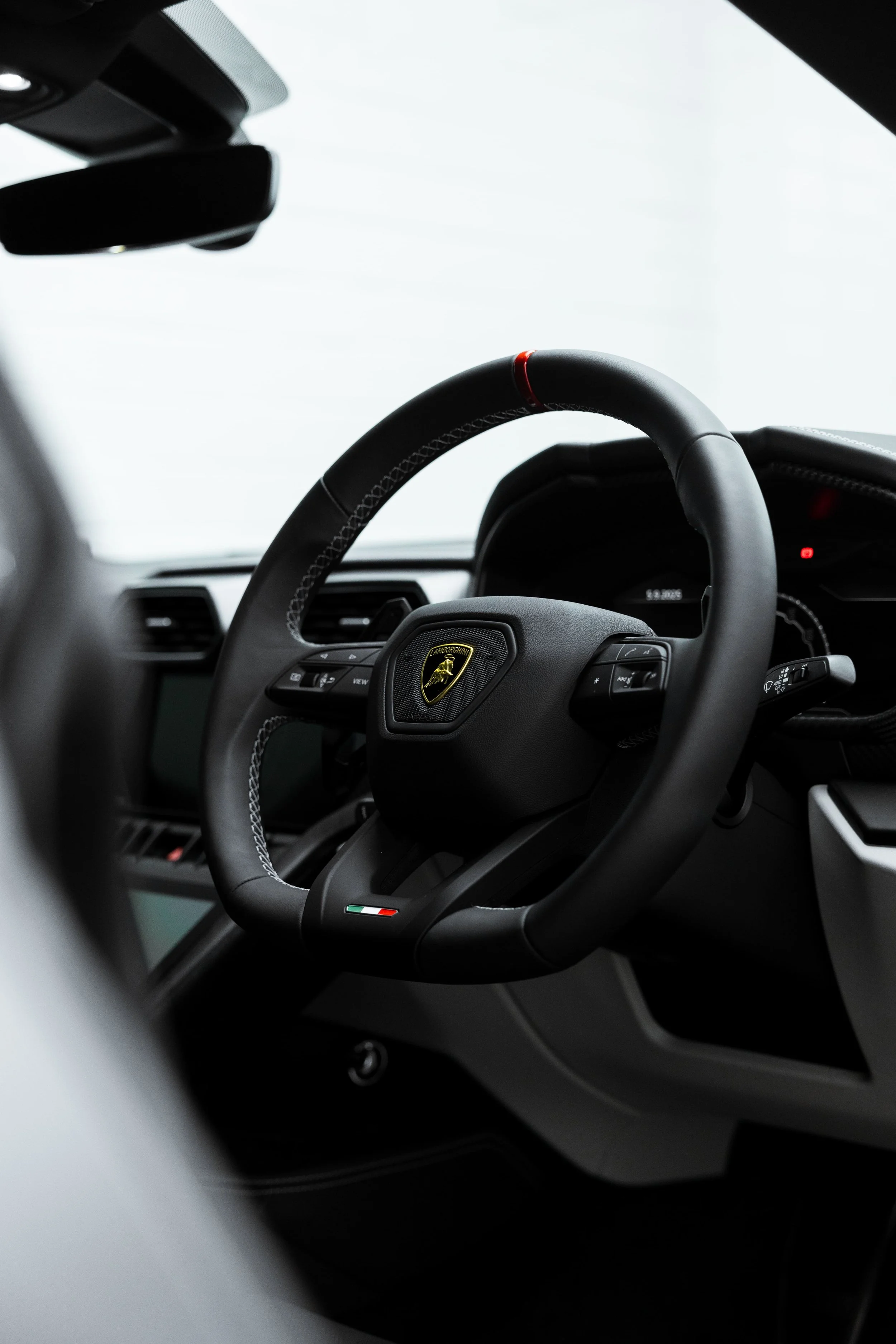 Interior view of Lamborghini Urus steering wheel and dashboard with premium detailing by ADS in Sydney
