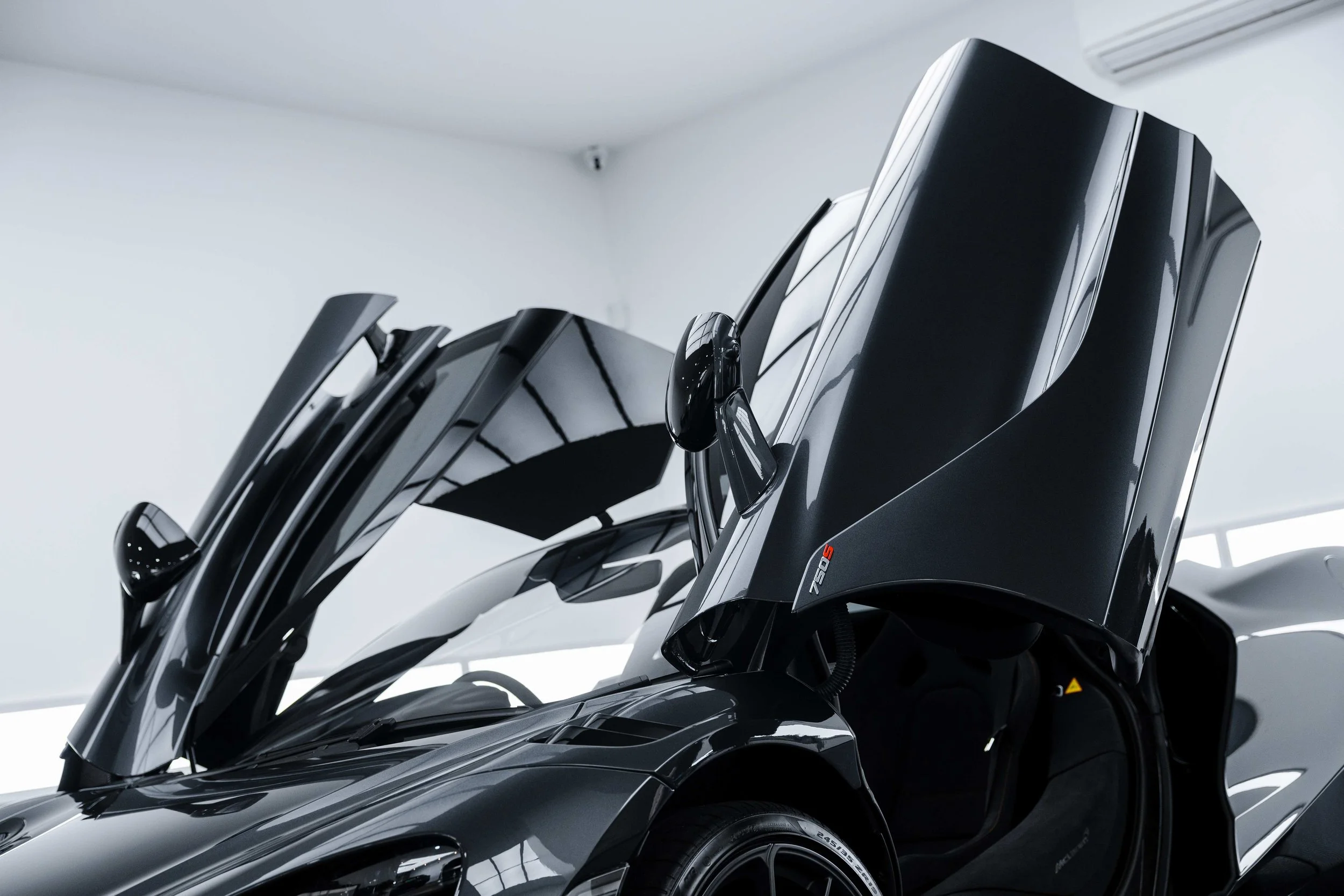 Black McLaren 750S dihedral door open side profile with XPEL Paint Protection Film in Sydney