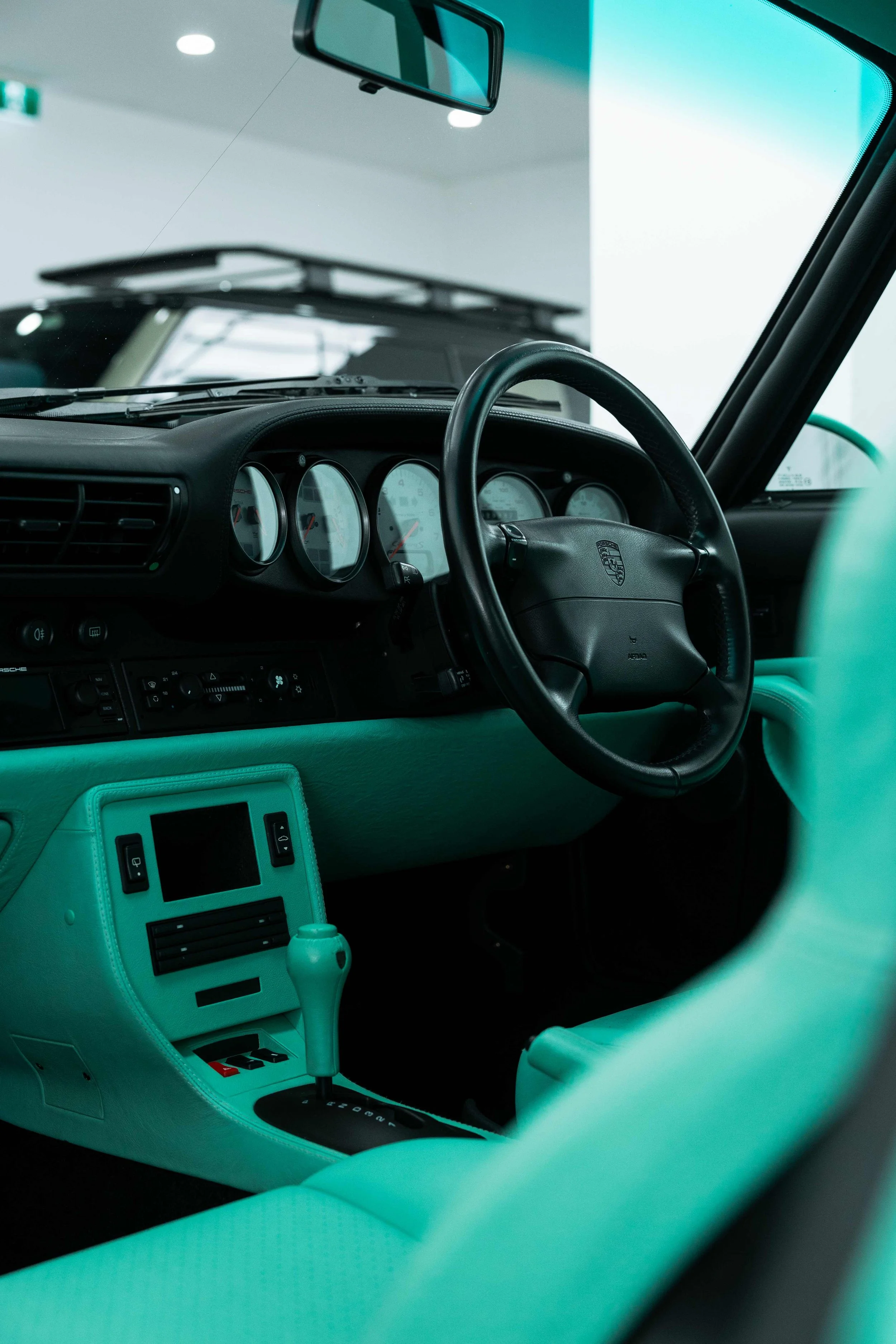 Porsche 993 dashboard, steering wheel, and mint green trim after interior detailing in Sydney