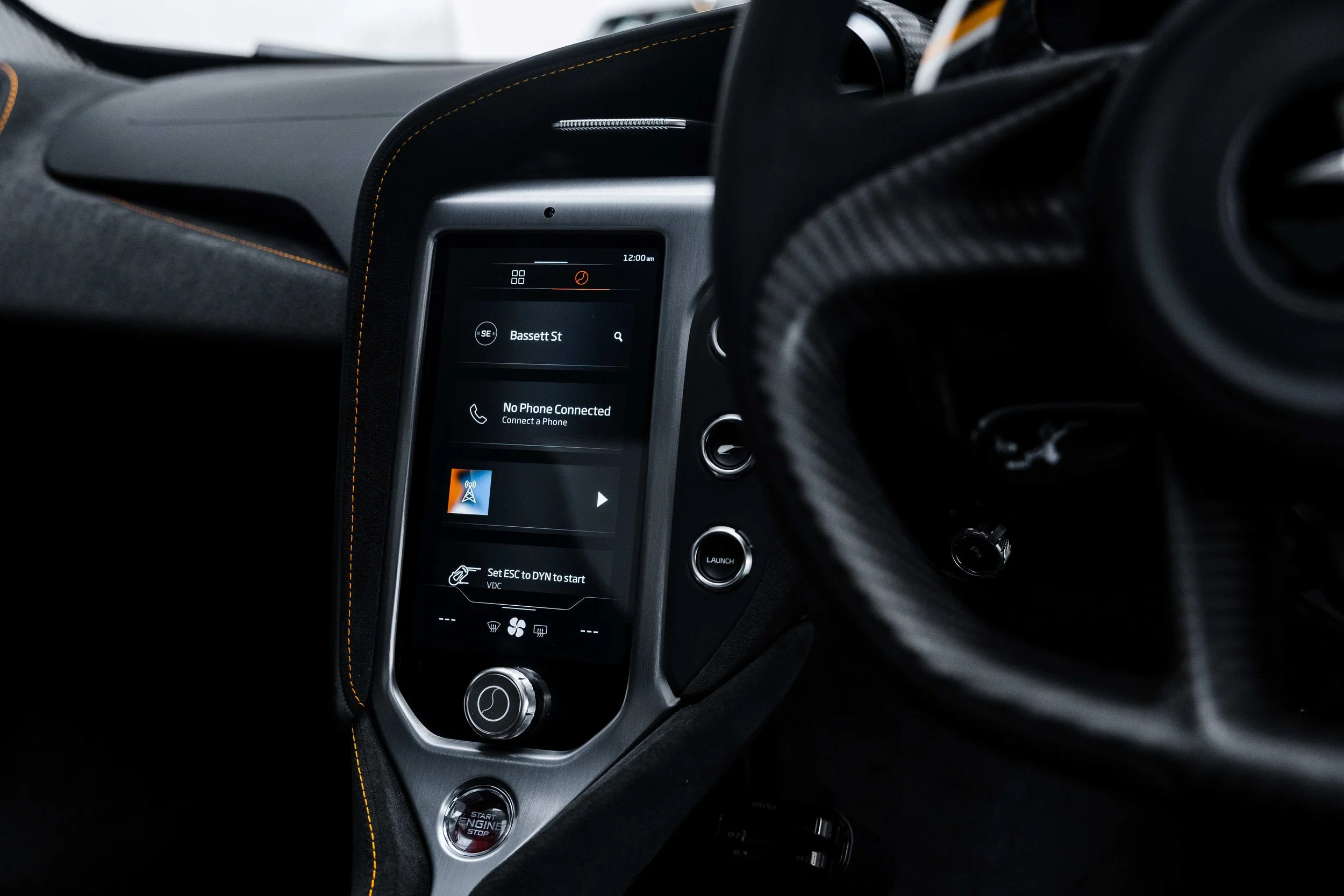 Black McLaren 750S interior detailing infotainment screen and steering wheel in Mona Vale