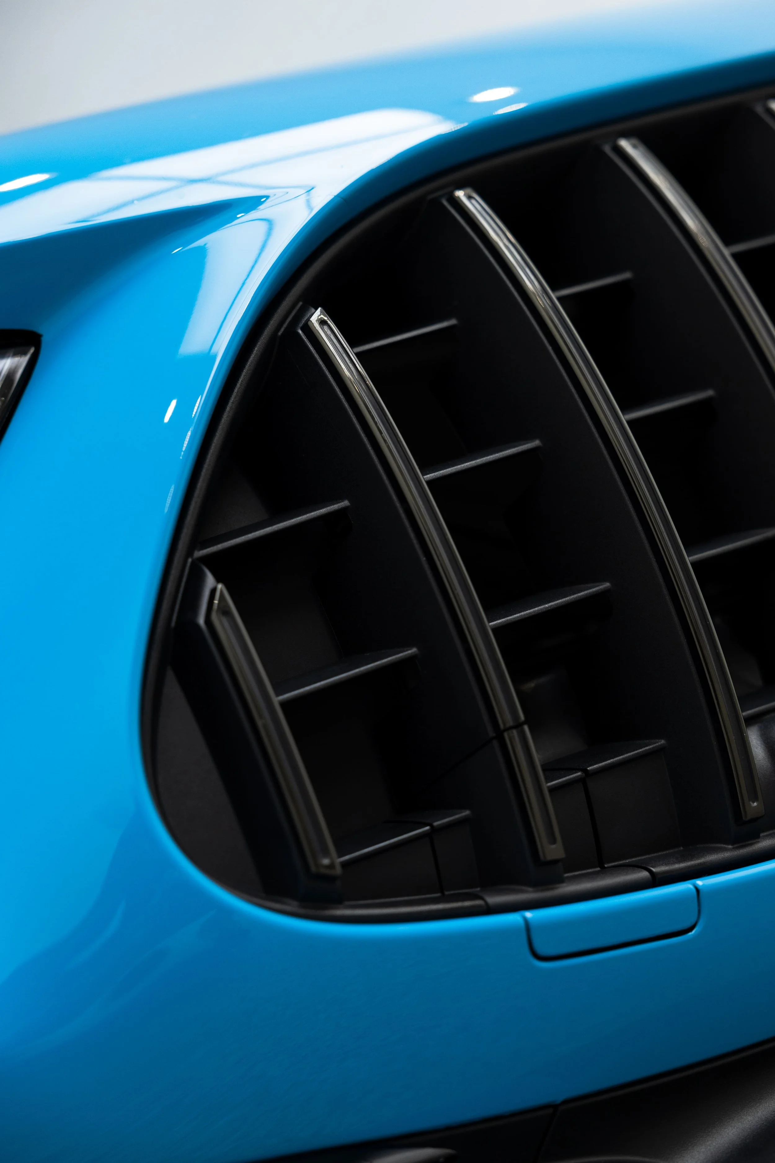 Close-up of Mercedes-AMG grille in blue custom wrap with paint protection film by ADS in Mona Vale