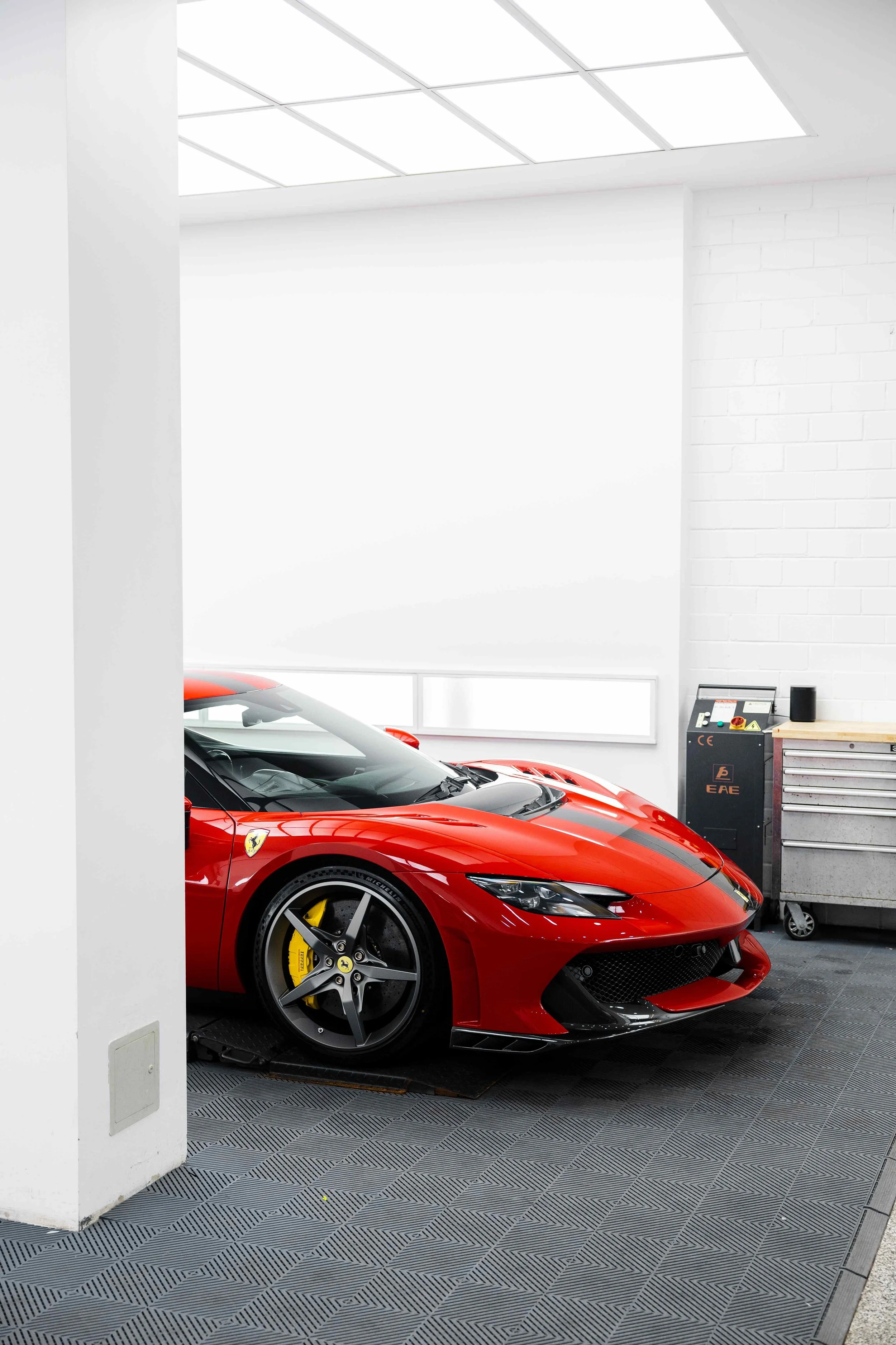 Red Ferrari 296 Speciale front quarter and wheel in studio with XPEL Paint Protection Film in Mona Vale