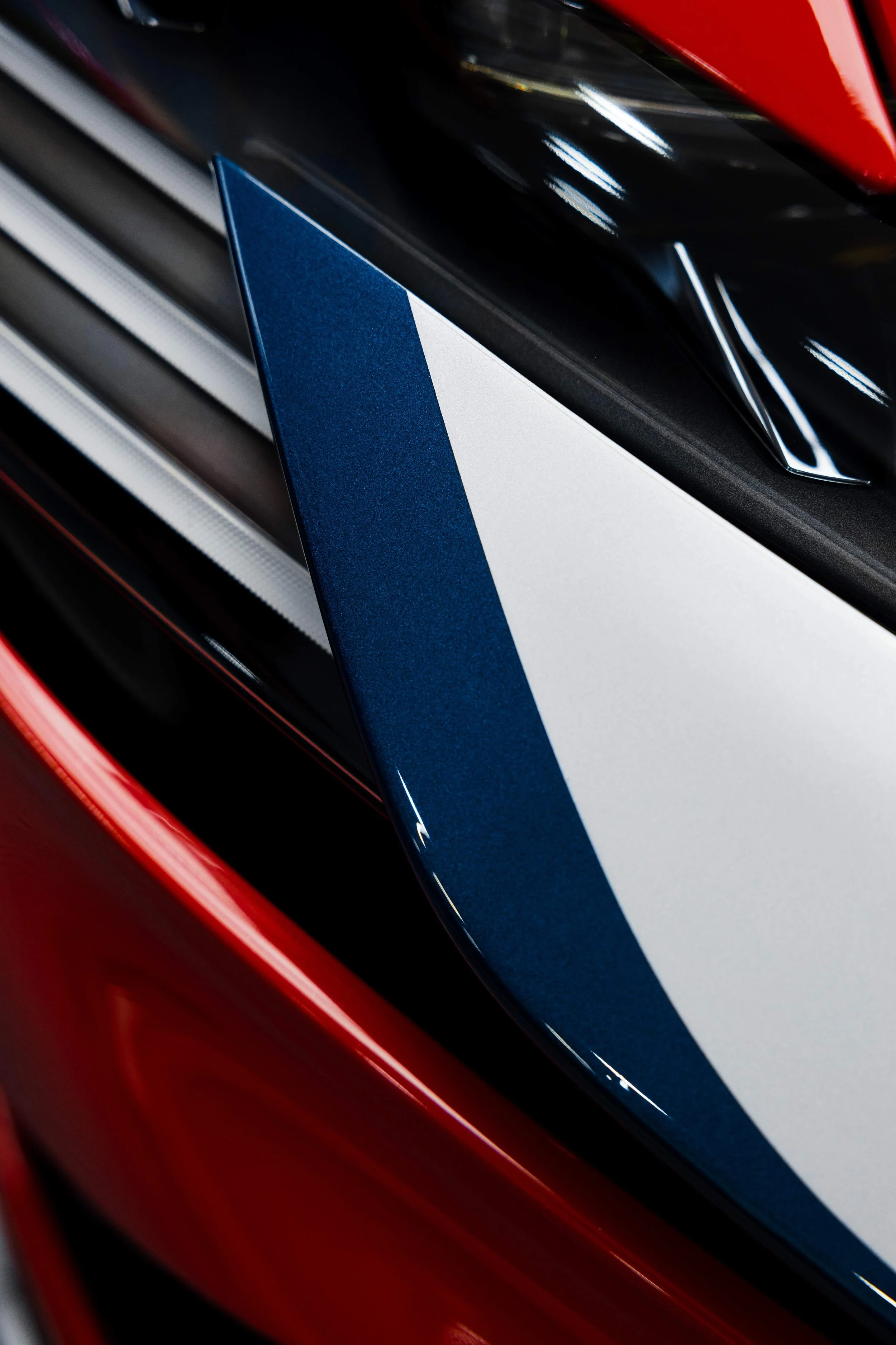 Red Ferrari SF90 Spyder front nose with blue and white stripe and XPEL Paint Protection Film in Sydney