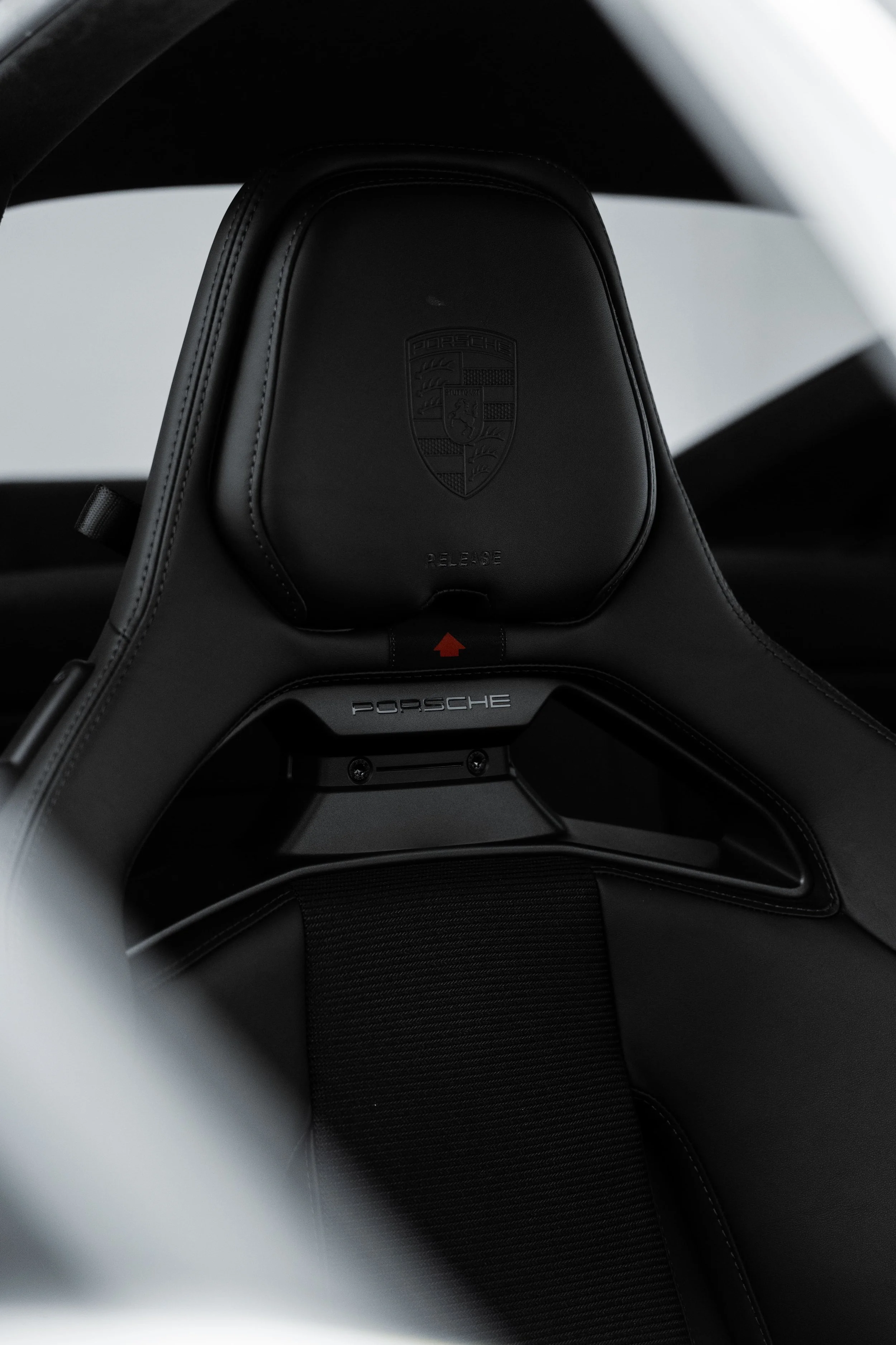 Porsche 911 GT3 Touring bucket seat detail with embossed Porsche crest and lightweight racing design, showcasing premium interior protected by Australian Detailing Services Sydney