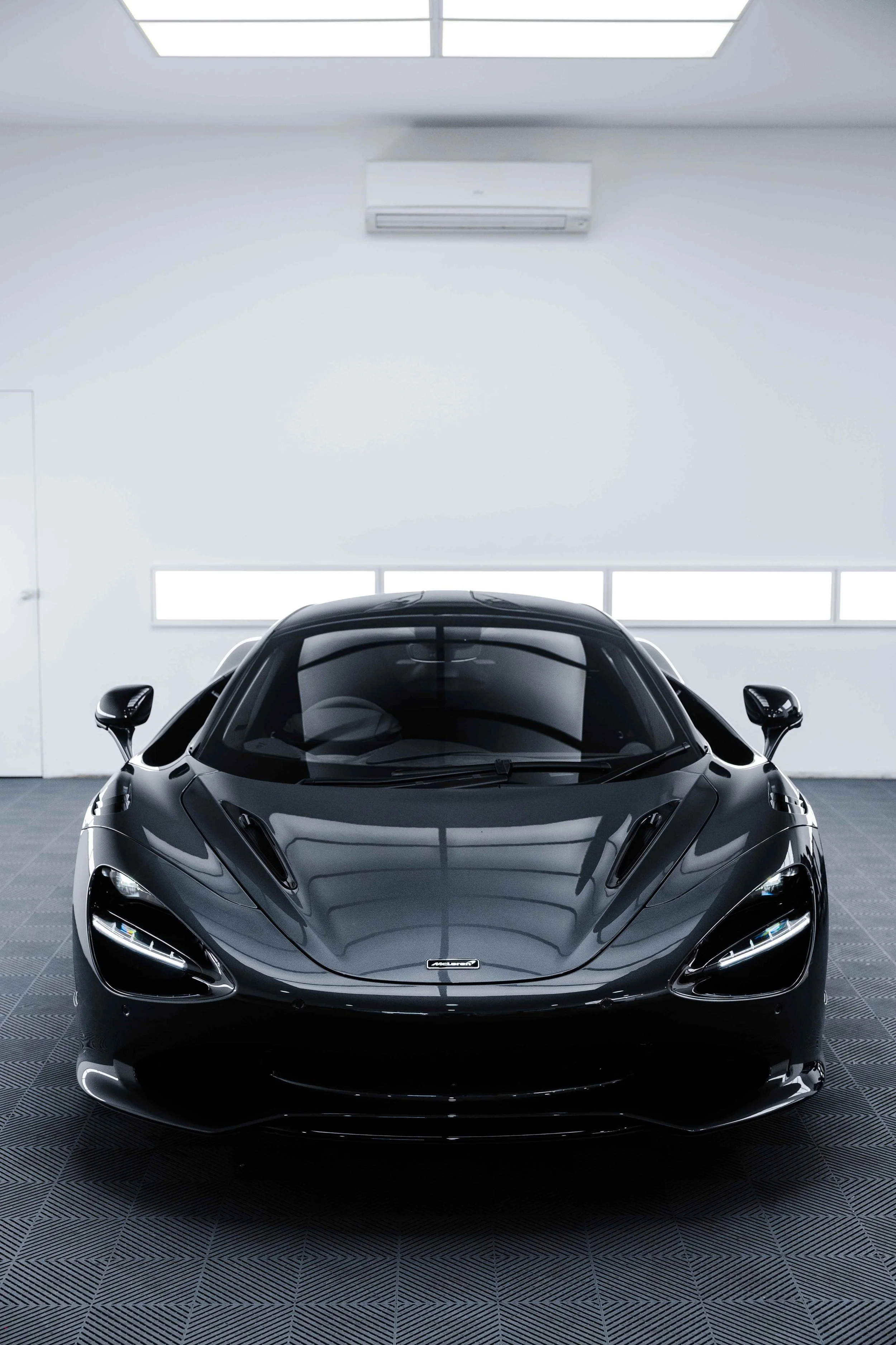 Black McLaren 750S front view in studio with XPEL Paint Protection Film in Sydney
