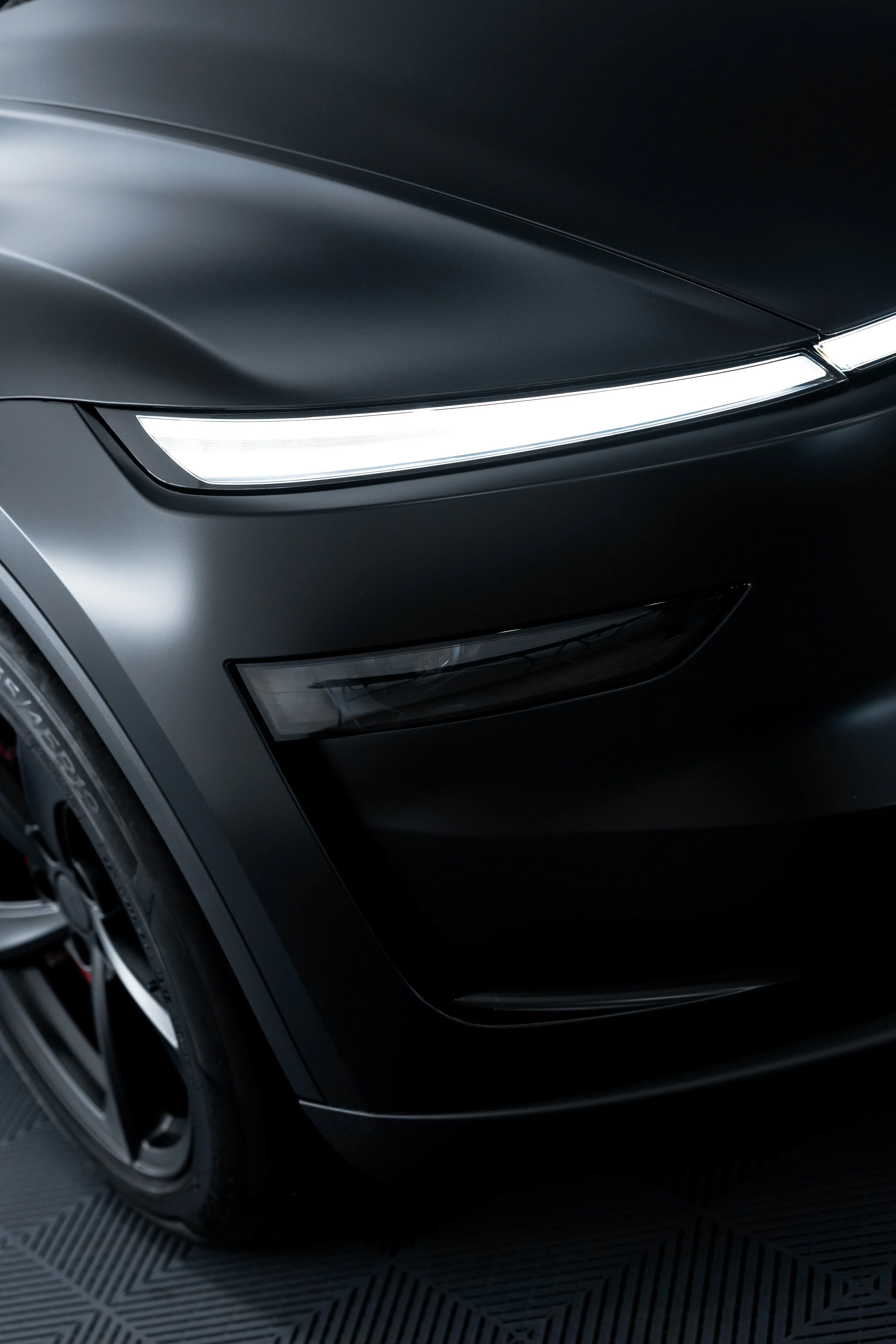 Matte black Tesla Model Y headlight and bonnet with XPEL Stealth Paint Protection Film in Mona Vale