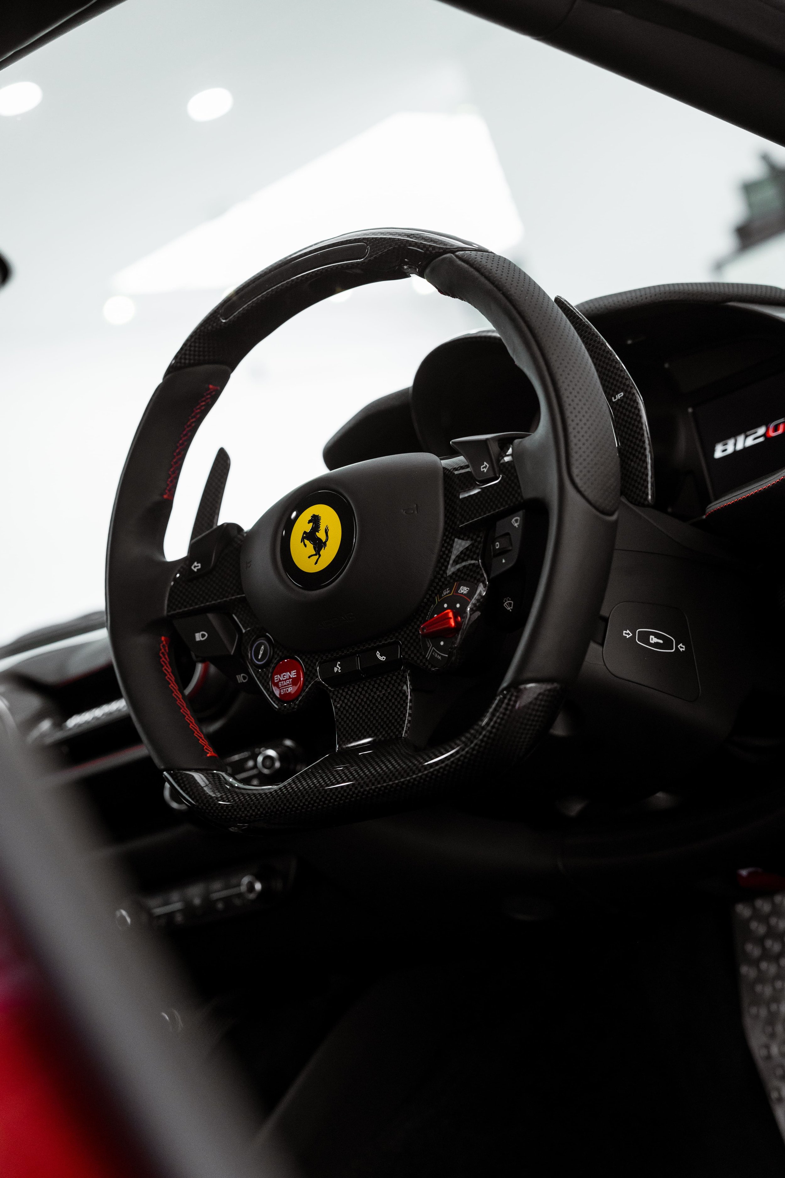 Ferrari 812 GTS steering wheel with carbon fibre trim and driver cockpit interior detailed by ADS in Sydney