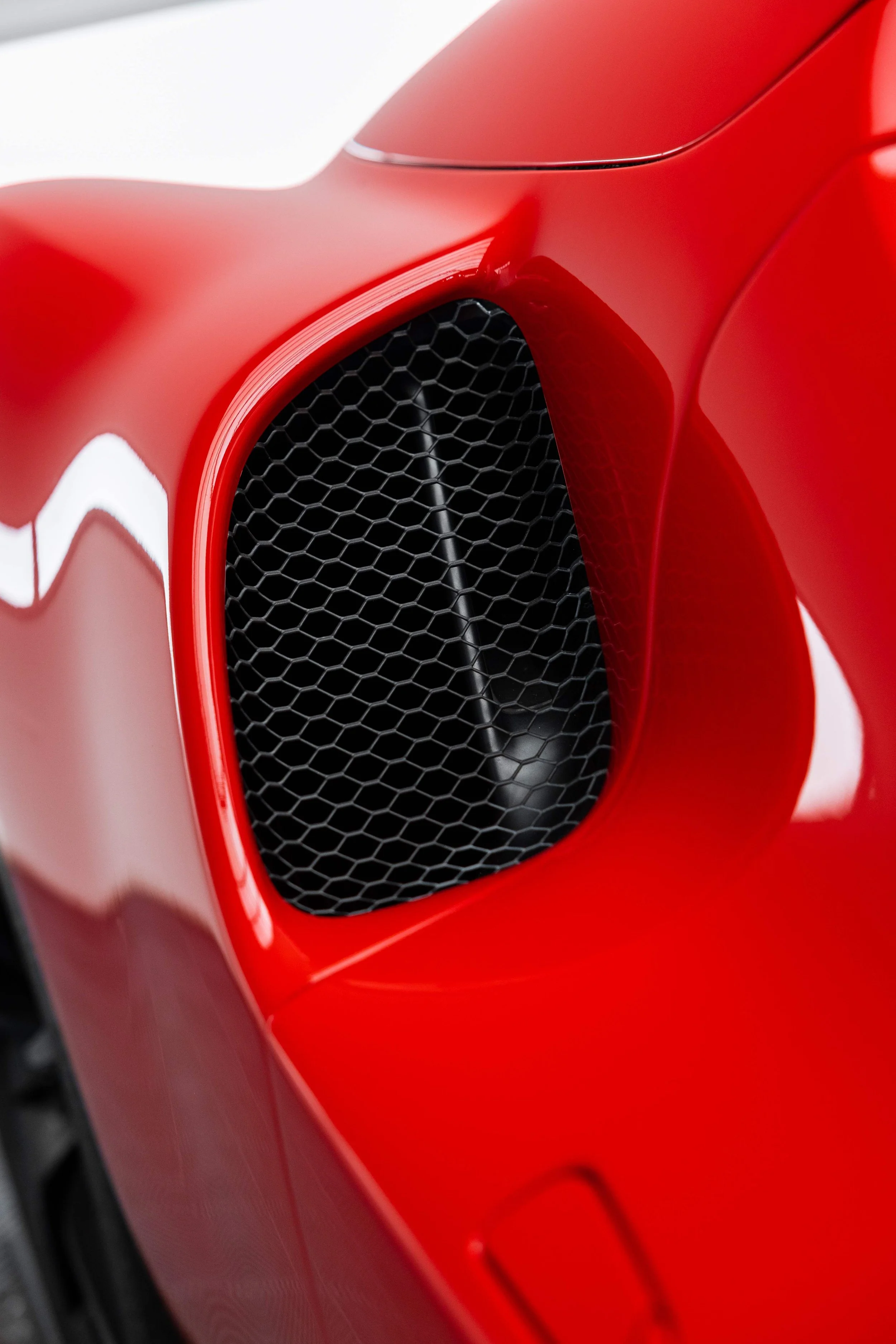 Red Ferrari 296 GTS side air vent detail with XPEL Paint Protection Film in Sydney