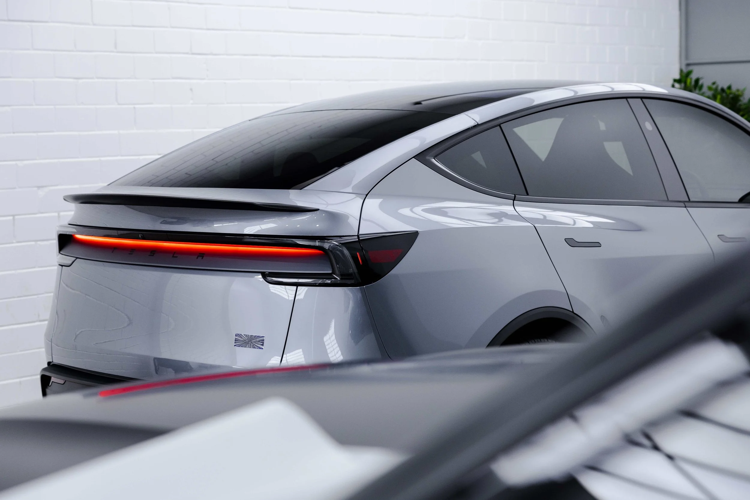 Silver Tesla Model Y rear quarter and taillight with XPEL Paint Protection Film in Sydney