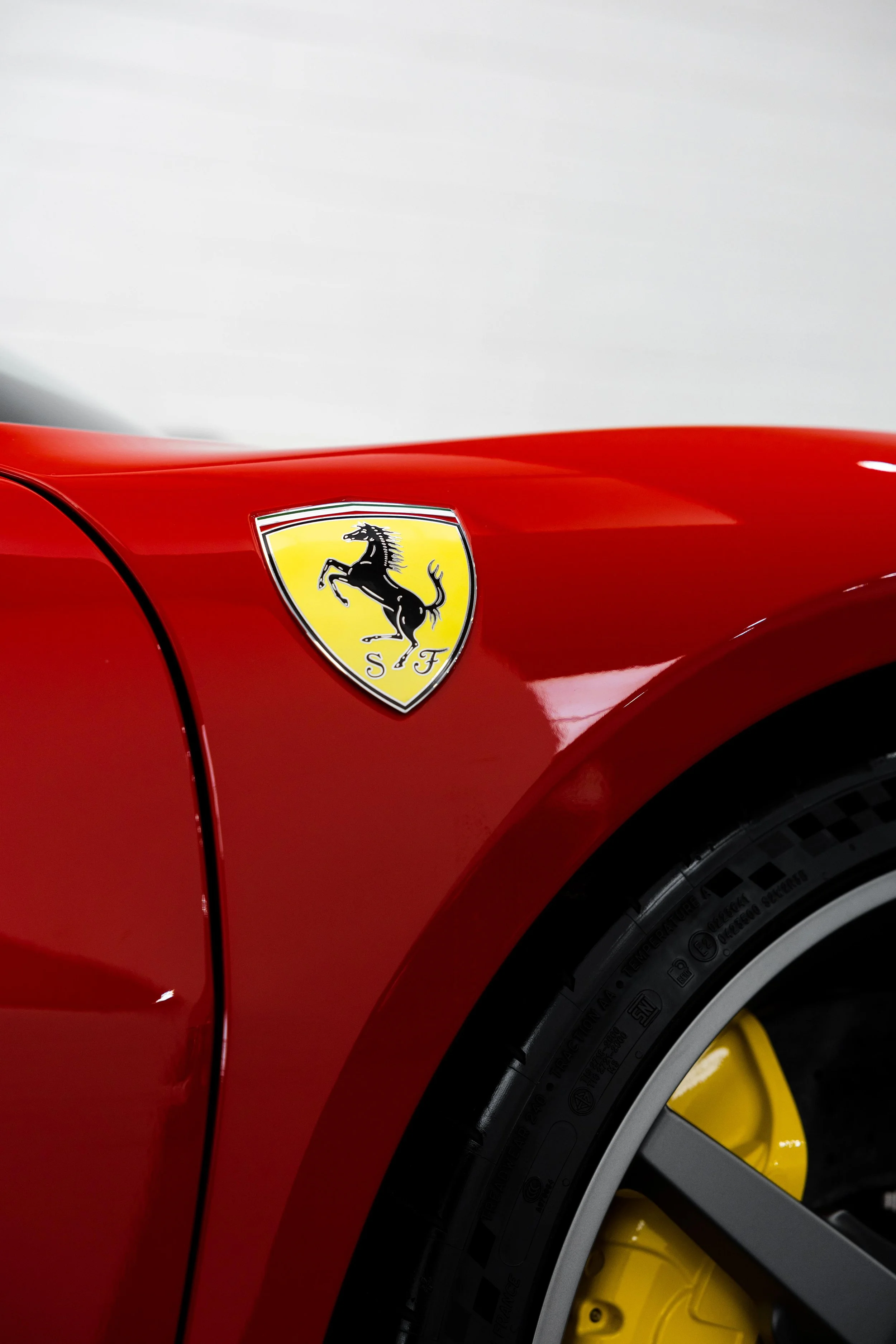 Red Ferrari 296 Speciale Scuderia shield badge on front guard with XPEL Paint Protection Film in Sydney