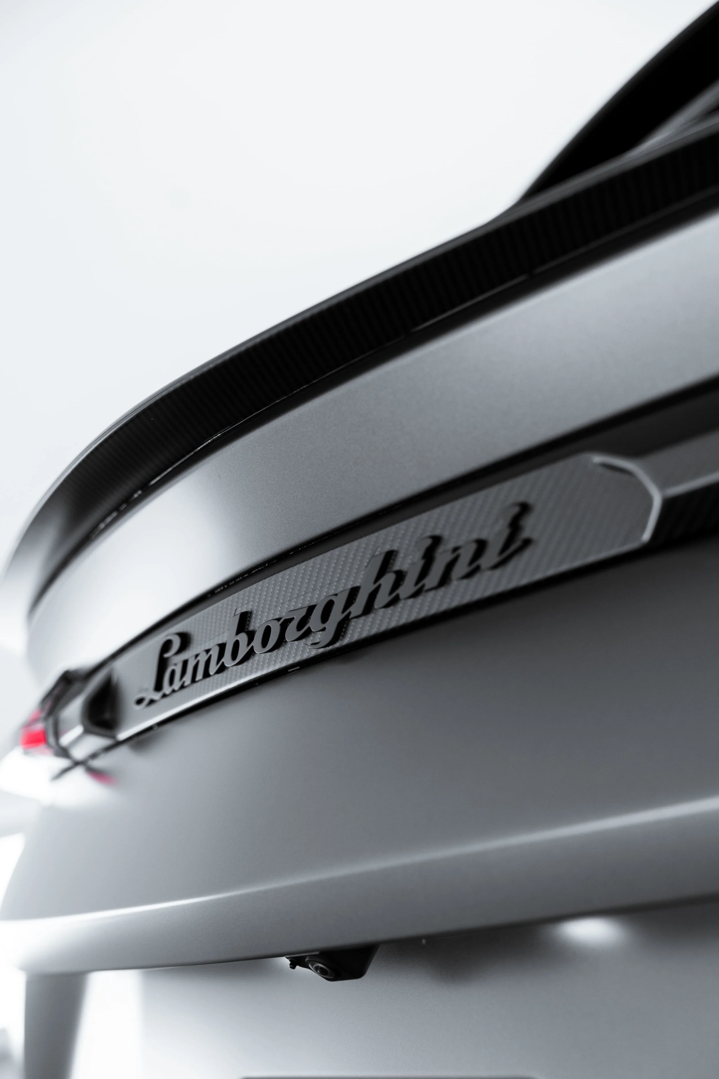 Lamborghini Urus rear badge detail with carbon fibre trim protected by PPF and detailing by ADS in Sydney