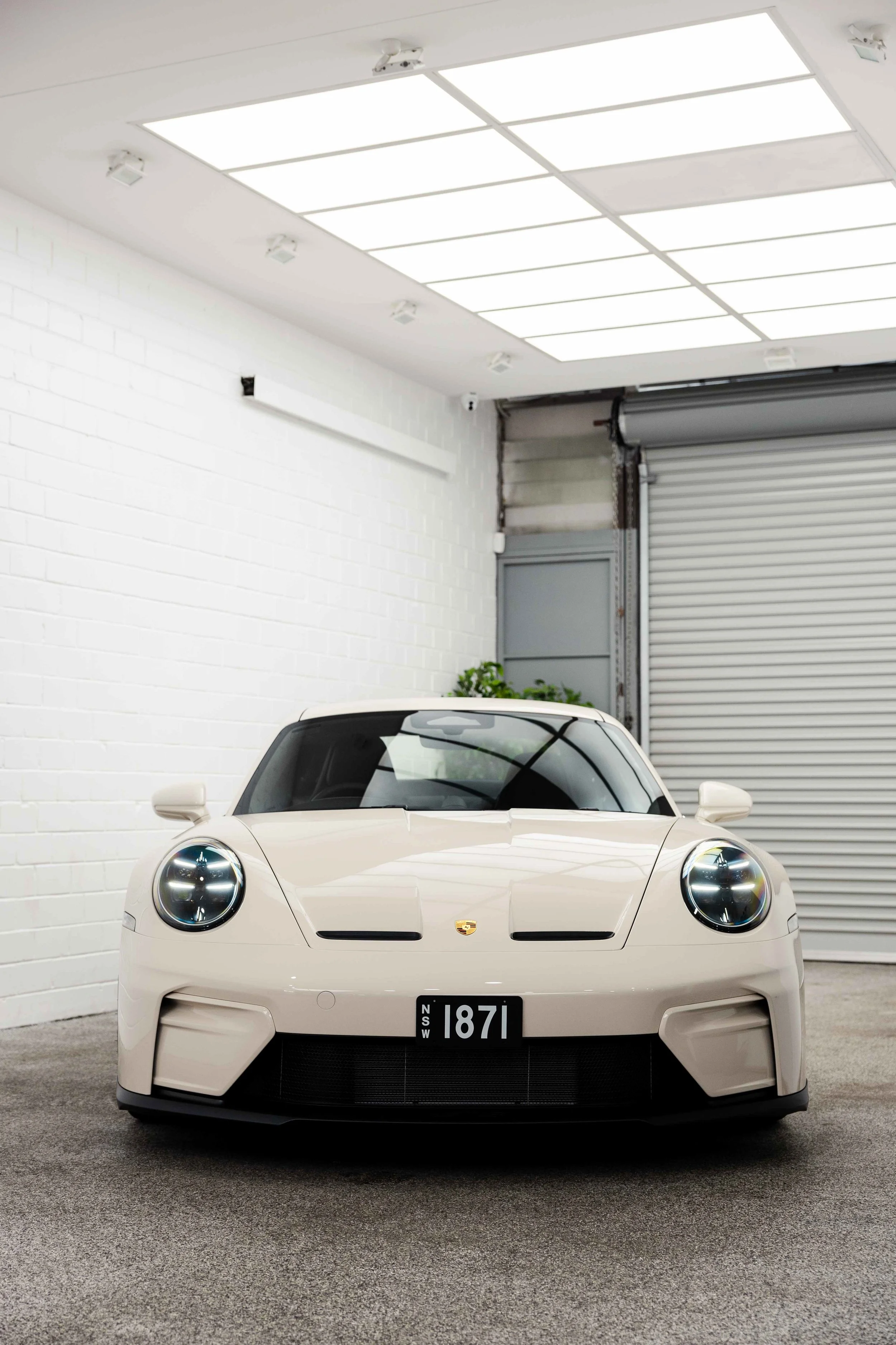 Cream Porsche 911 GT3 Touring front view in studio with XPEL Paint Protection Film in Sydney