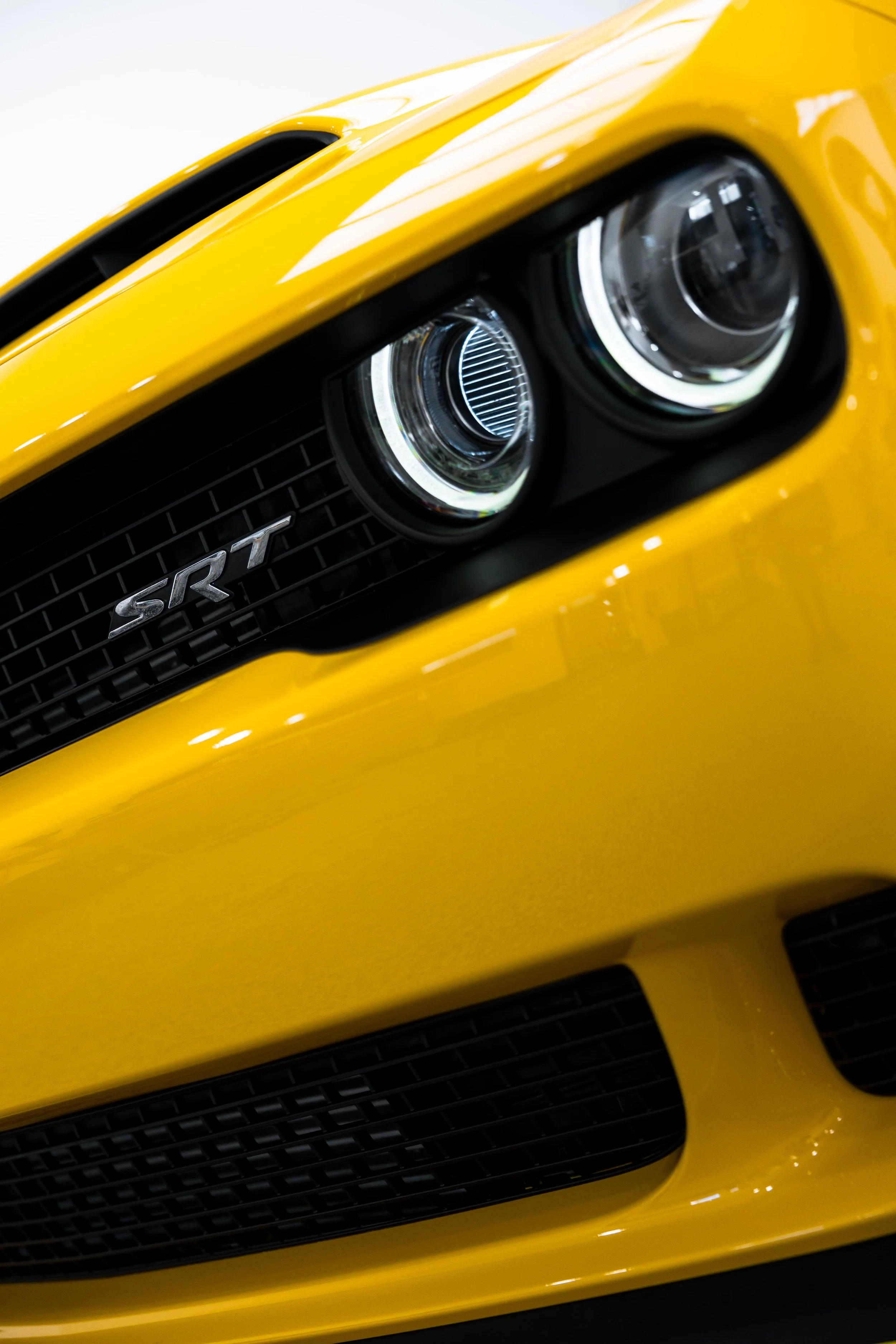 Close-up of yellow Dodge Challenger SRT Demon front grille and headlights with PPF by ADS in Mona Vale