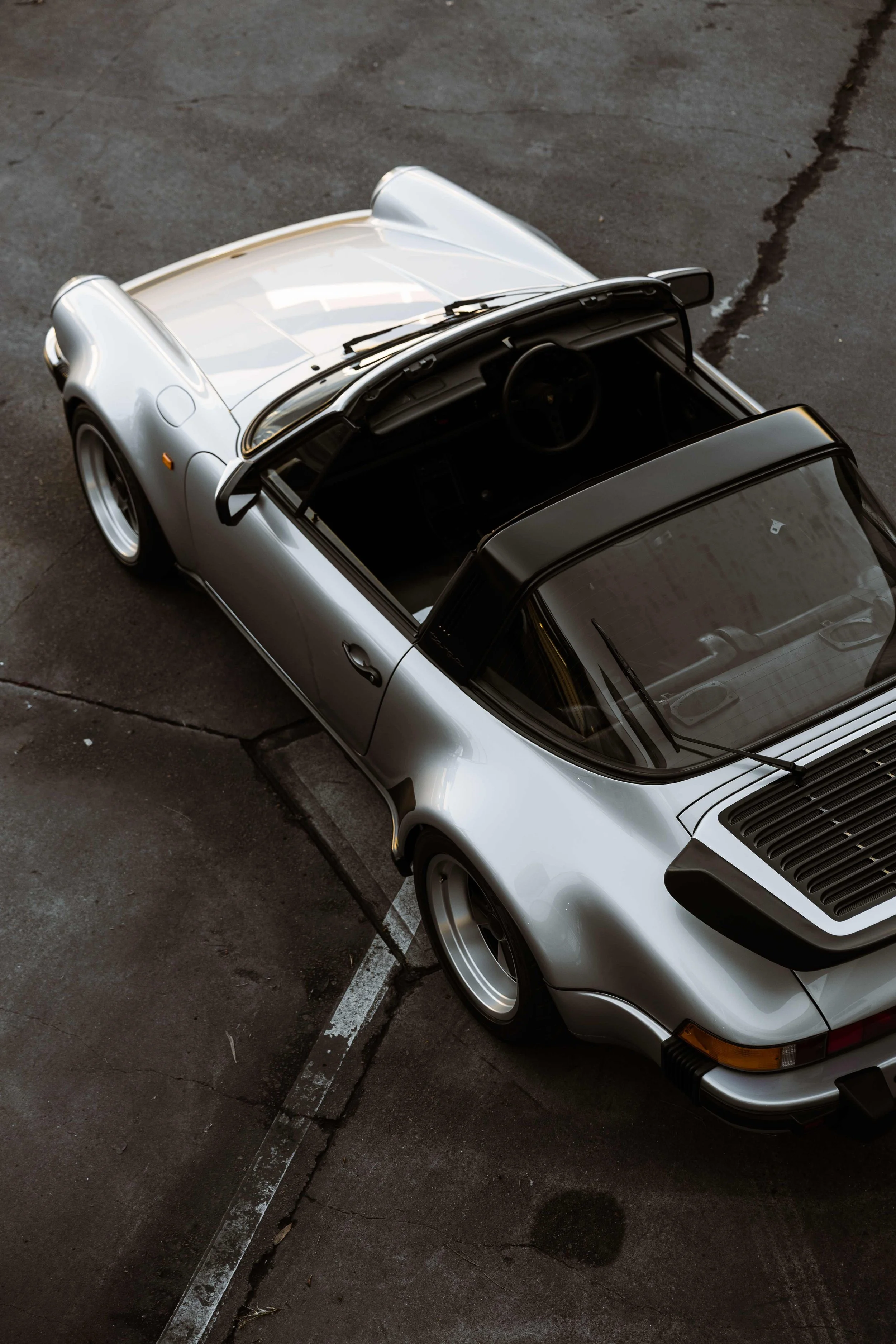 Silver 1989 Porsche 911 Carrera Targa aerial view roof off in Mona Vale