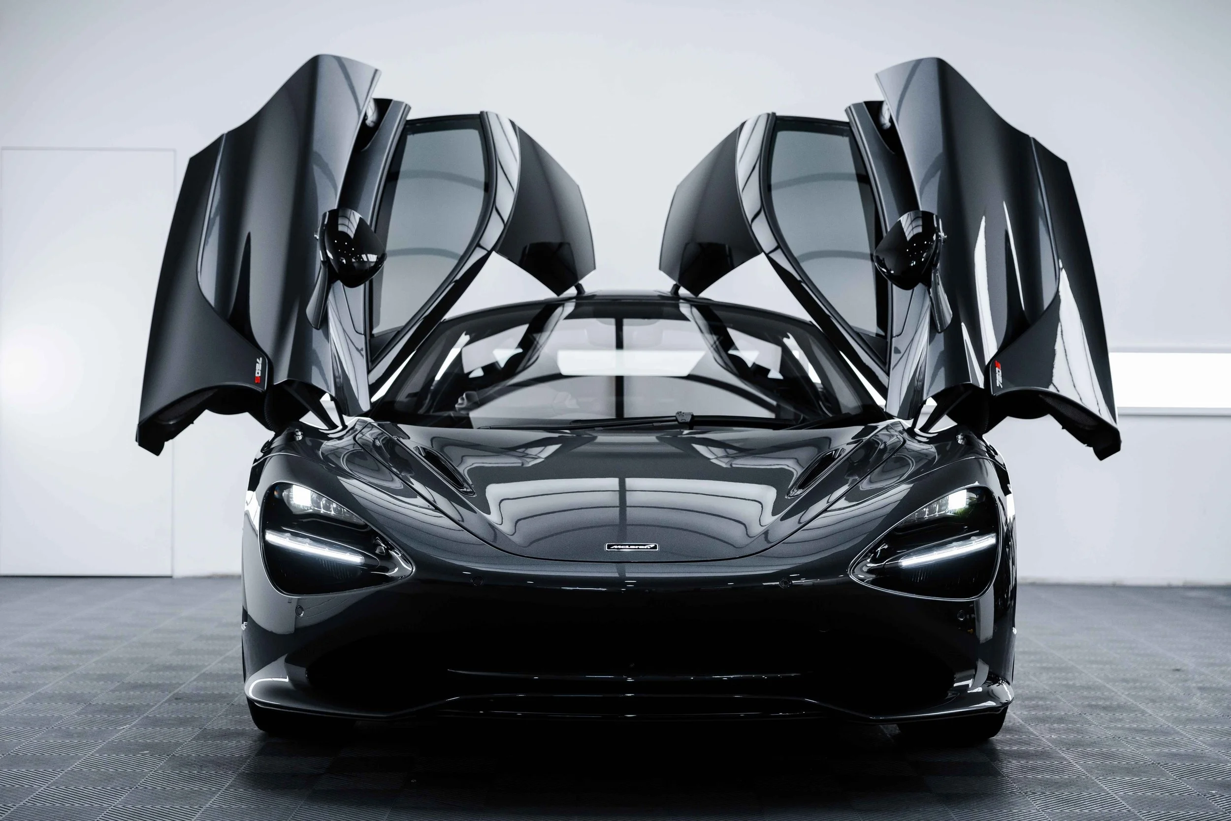 Black McLaren 750S dihedral doors open front view with XPEL Paint Protection Film in Mona Vale