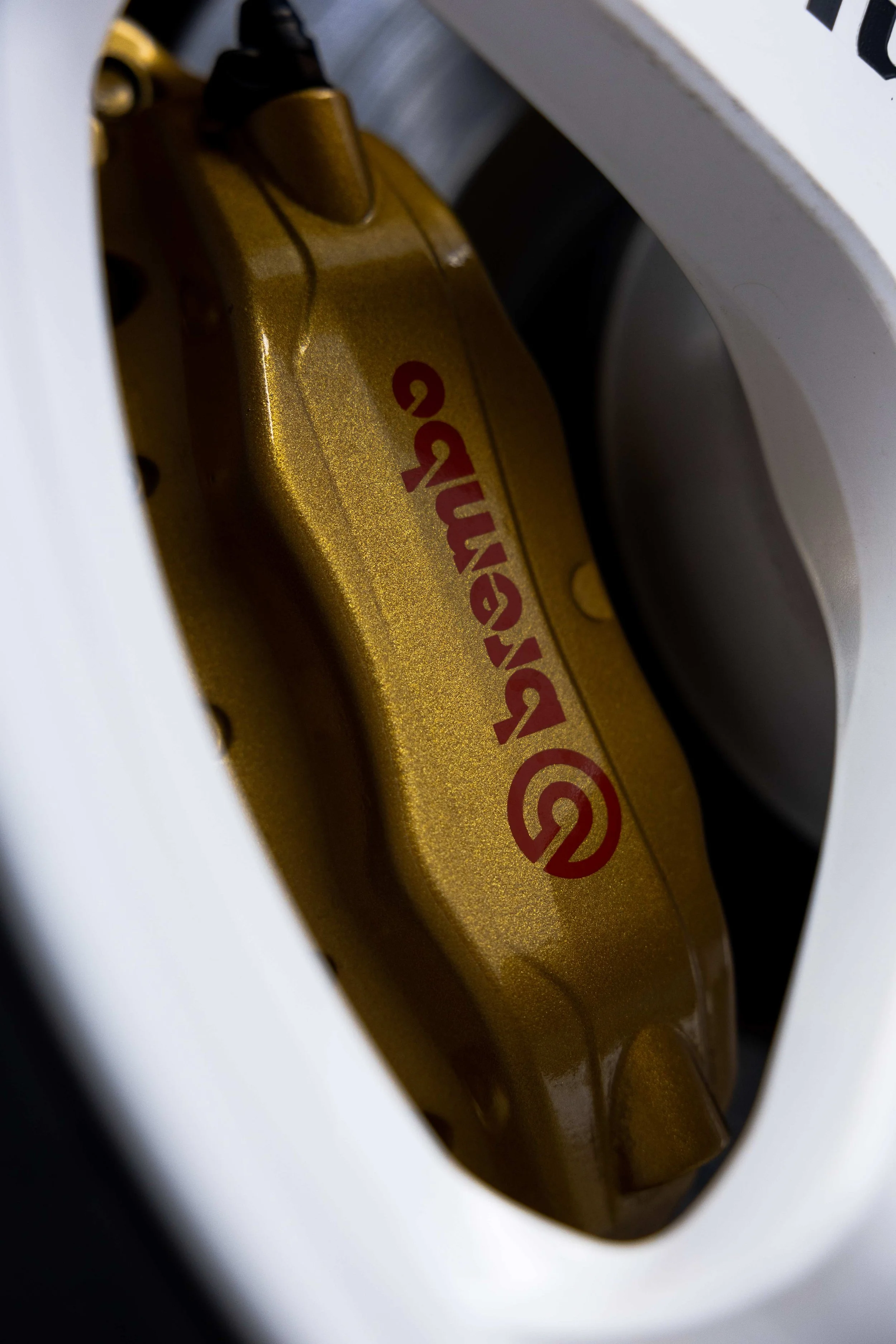 Gold Brembo brake caliper on Nissan R34 GT-R Nur after detailing in Sydney