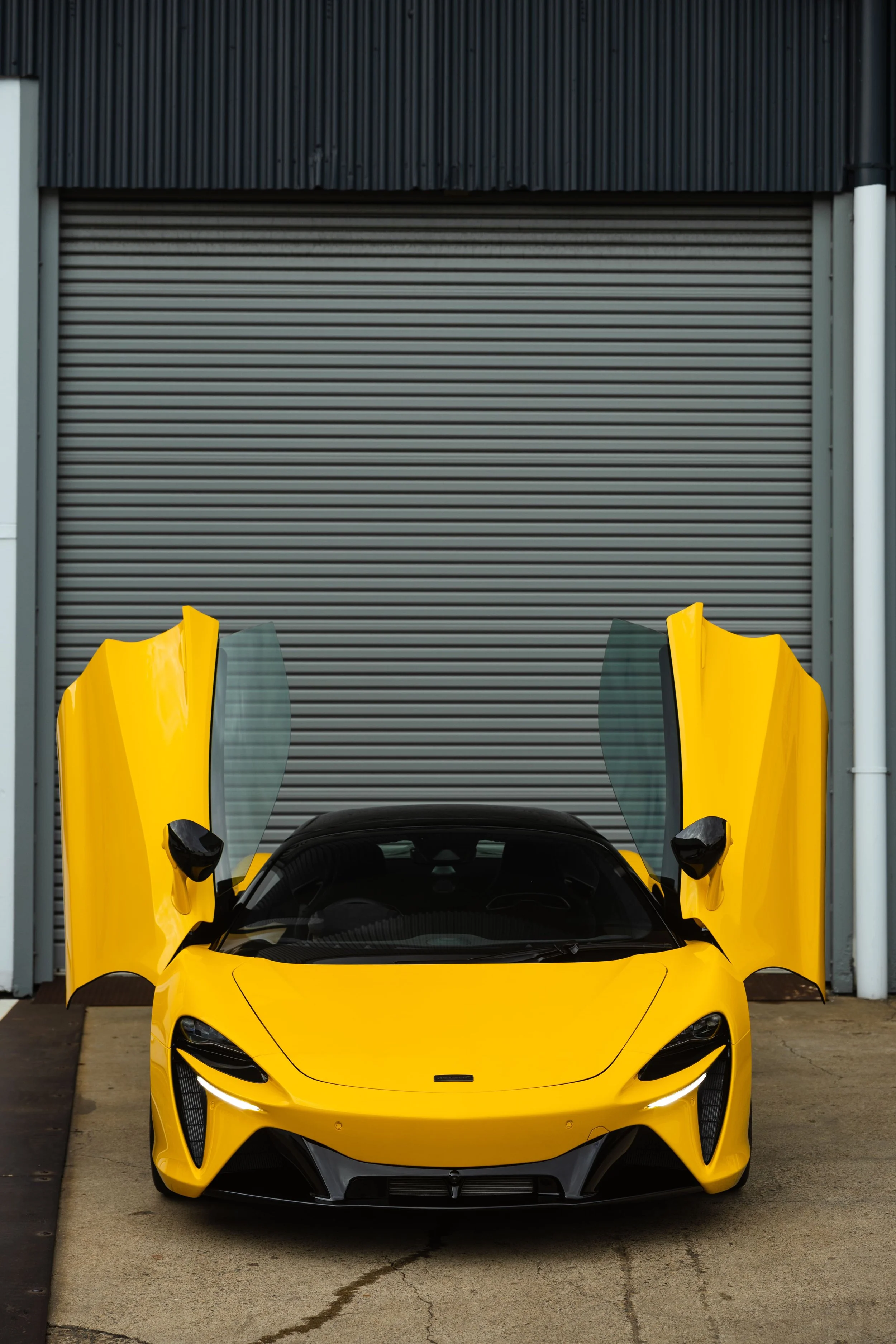 Yellow McLaren Artura front view with doors open and full PPF protection by ADS in Mona Vale