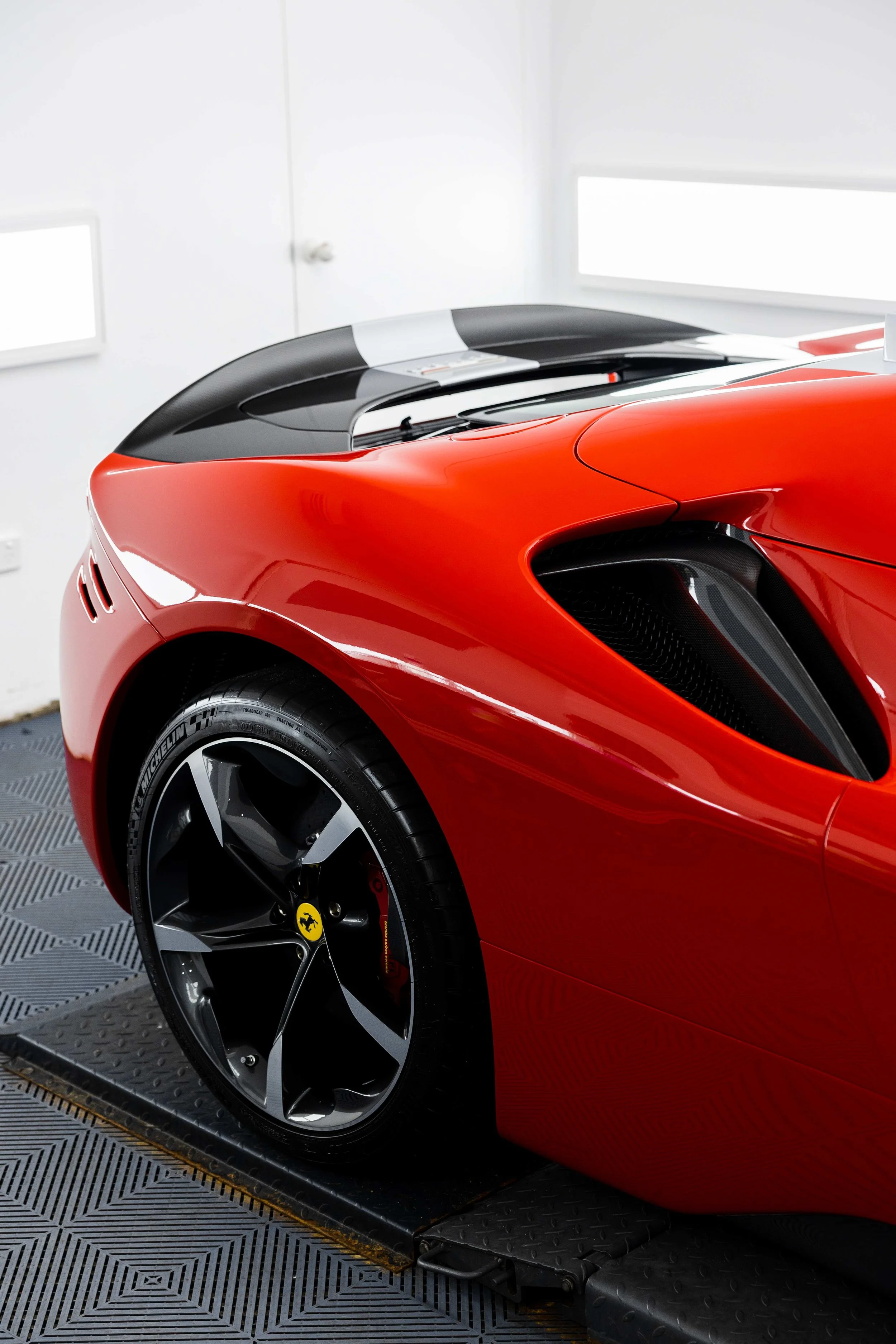 Red Ferrari SF90 Spyder rear quarter, air intake and wheel with XPEL Paint Protection Film in Sydney
