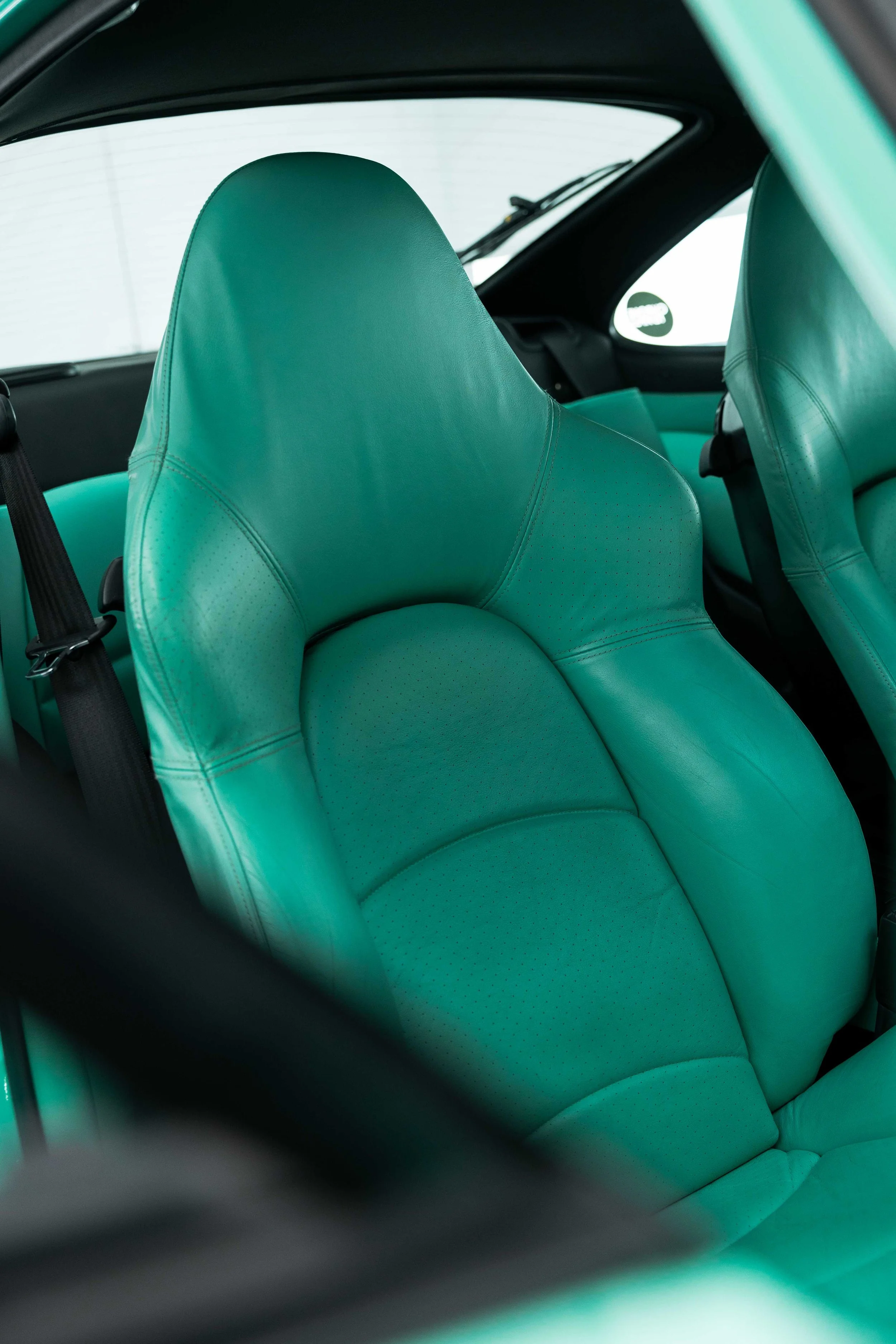Mint green leather seat after interior detailing in Sydney