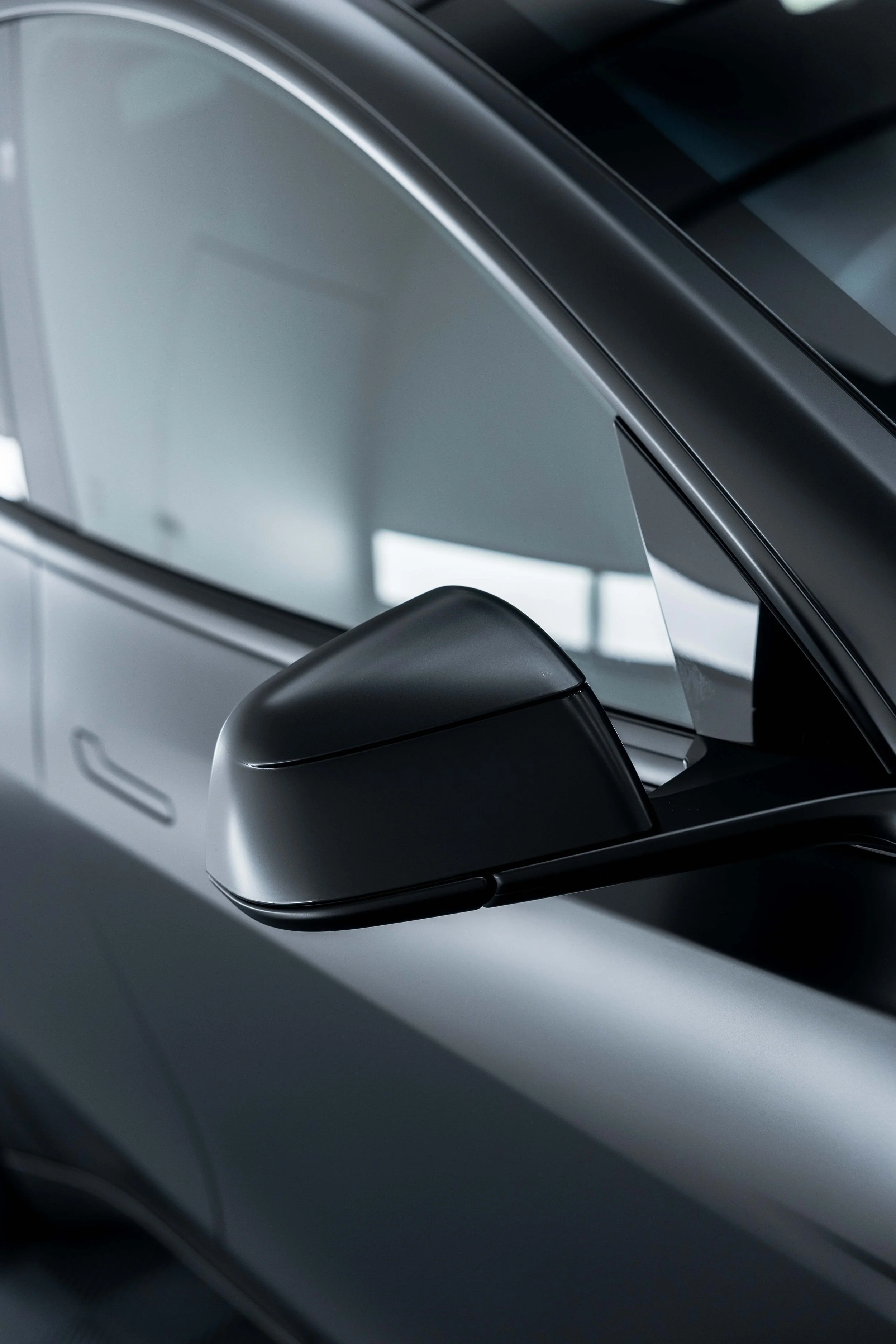 Matte black Tesla Model Y wing mirror and window trim with XPEL Stealth Paint Protection Film in Mona Vale