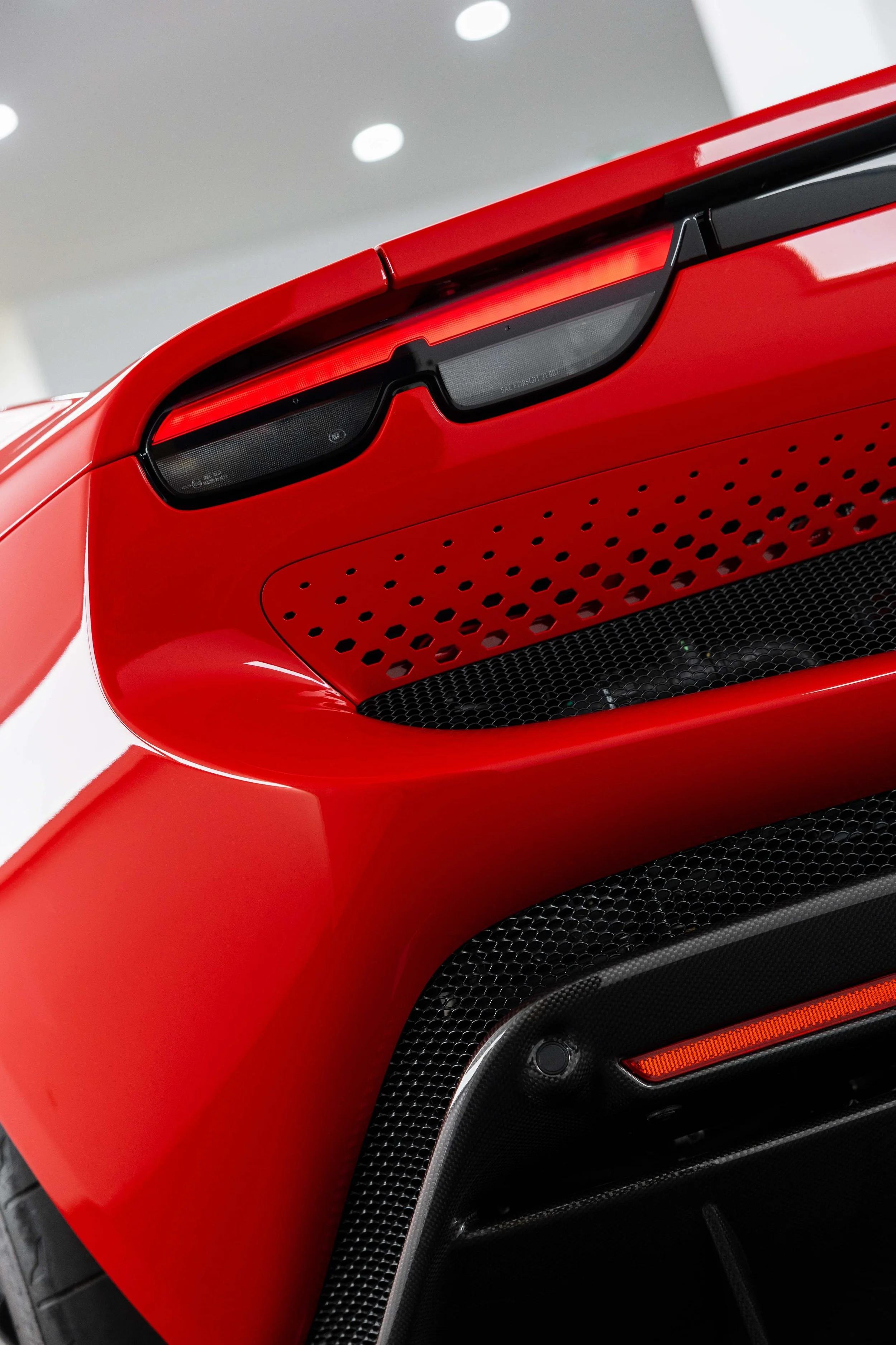 Red Ferrari 296 GTS taillight and rear vent detail with XPEL Paint Protection Film in Mona Vale