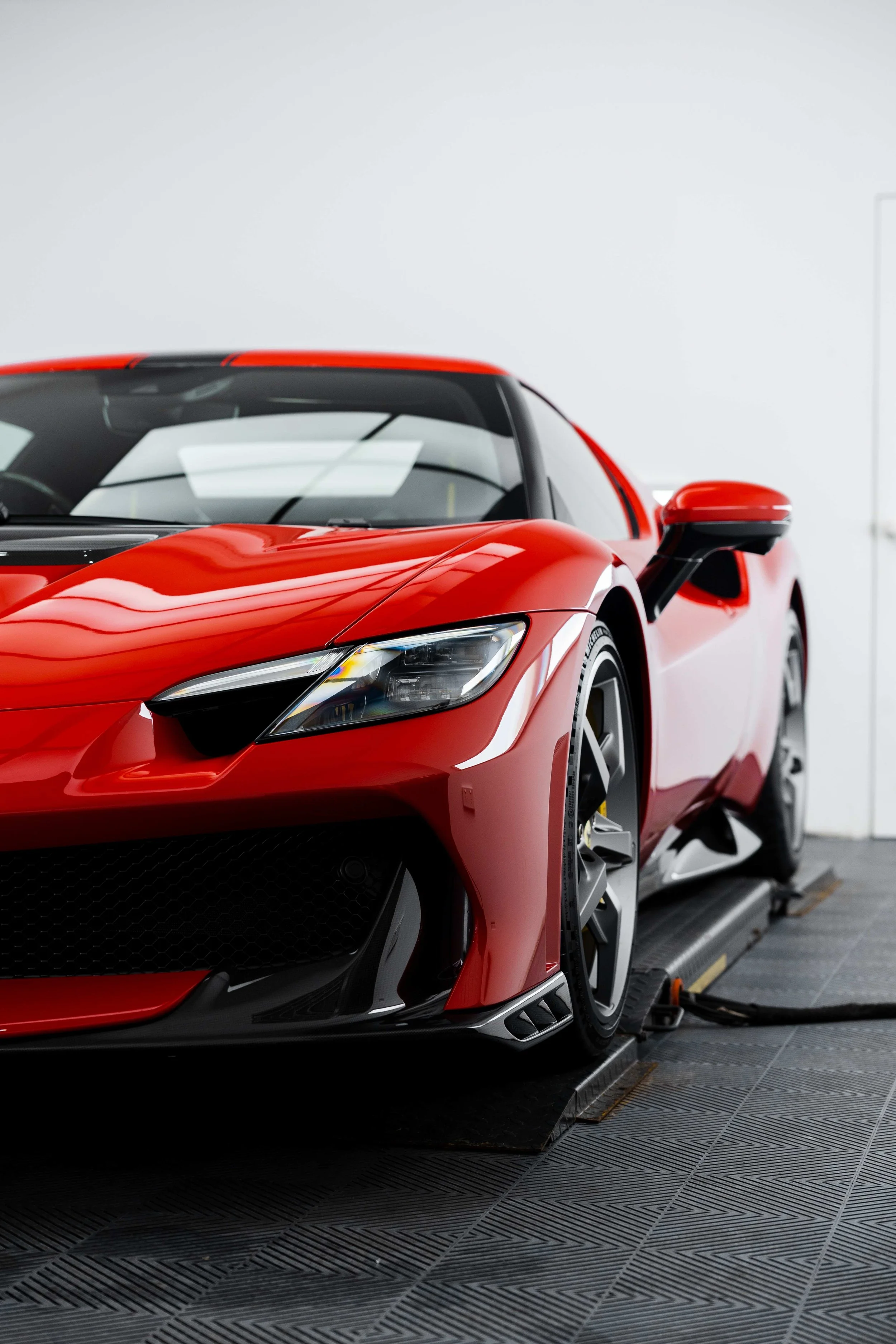 Red Ferrari 296 Speciale front quarter and headlight in studio with XPEL Paint Protection Film in Sydney