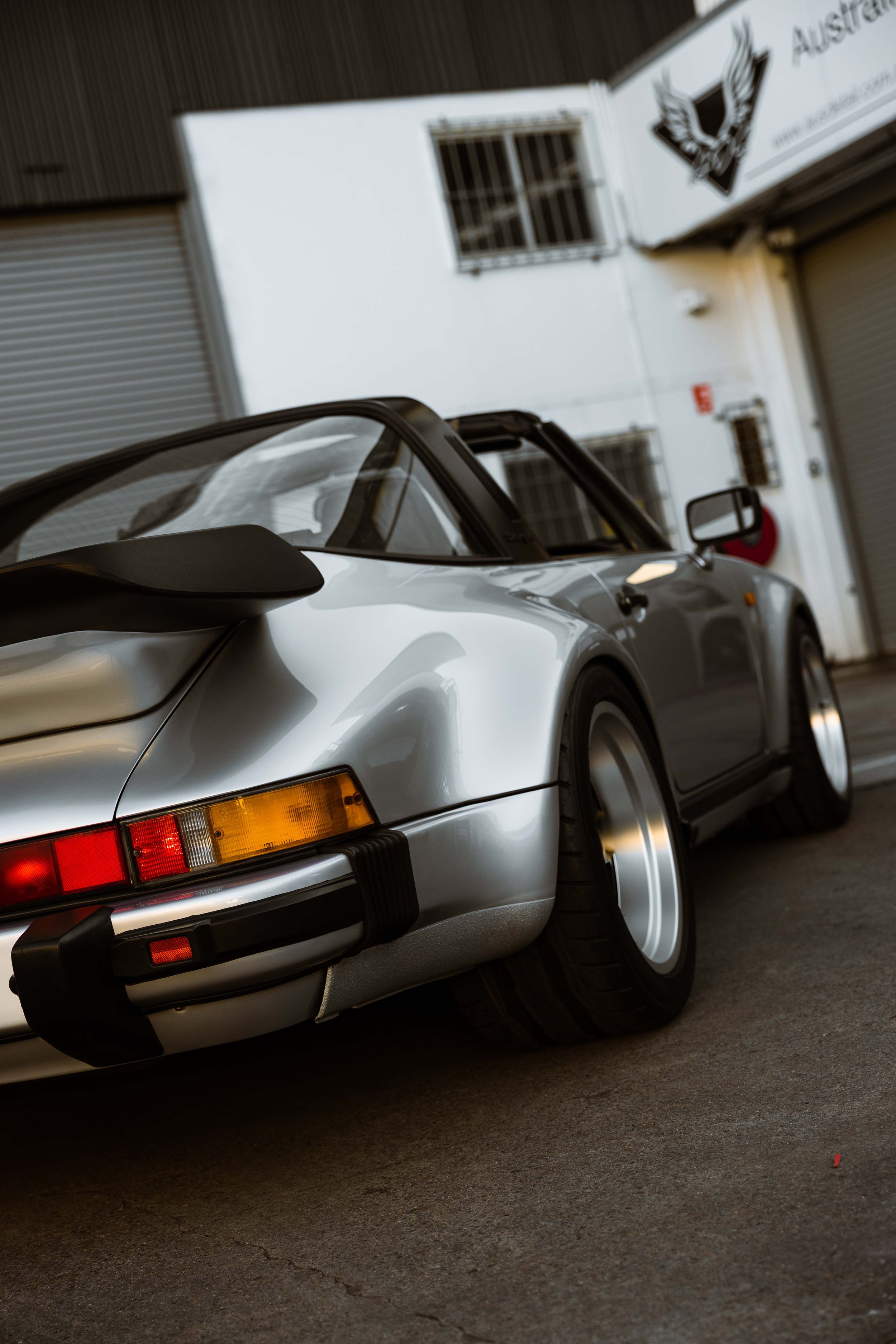 Silver 1989 Porsche 911 Carrera Targa rear quarter and taillight in Mona Vale