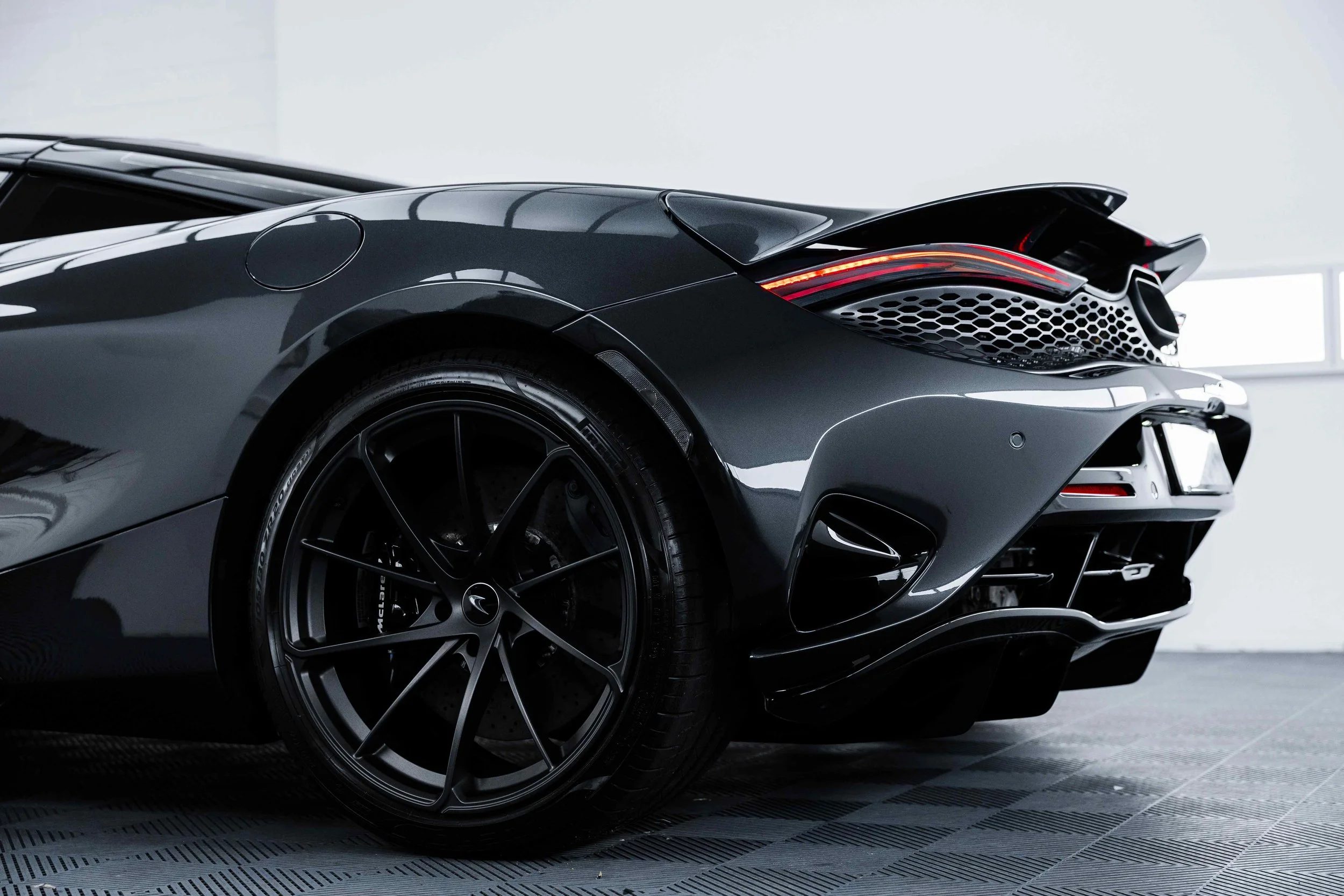 Black McLaren 750S rear quarter and wheel with XPEL Paint Protection Film in Mona Vale