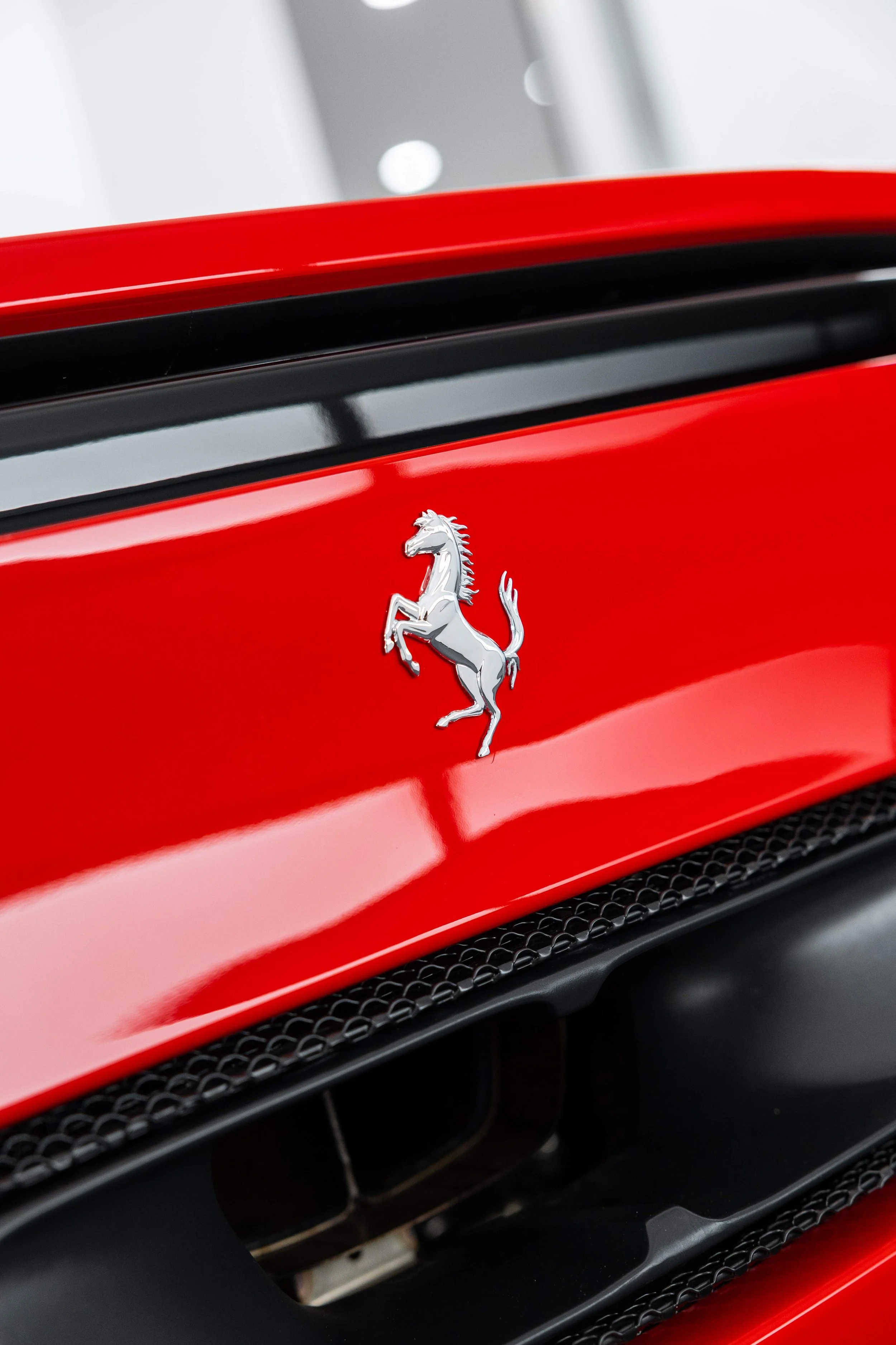 Red Ferrari 296 GTS Prancing Horse badge on bonnet with XPEL Paint Protection Film in Mona Vale